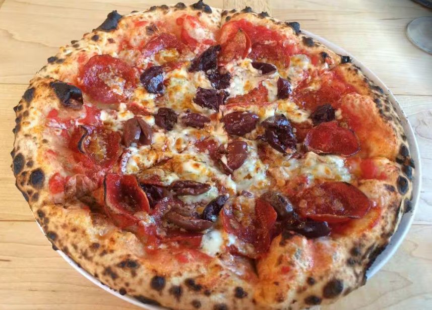 Charred round pie with pepperoni and dark olives, 15 North Pizza