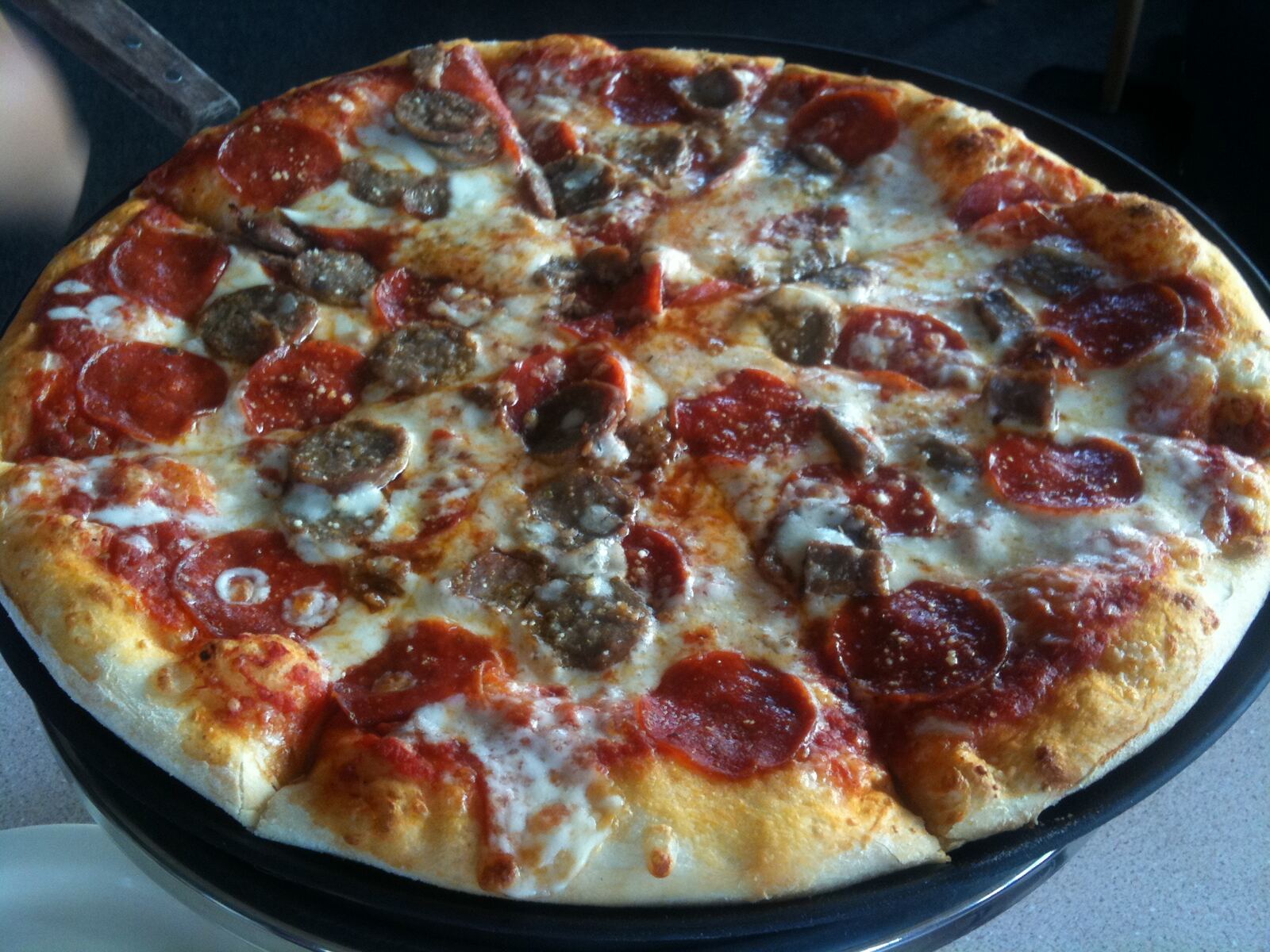 Pepperoni-topped pie with sausage bits and mozzarella dollops, Aponte's Pizza