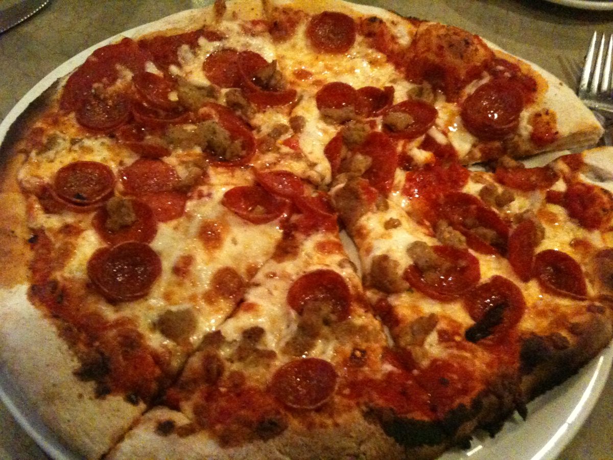 Blistered cheese pie topped with pepperoni and sausage chunks, Betta's Italian Oven