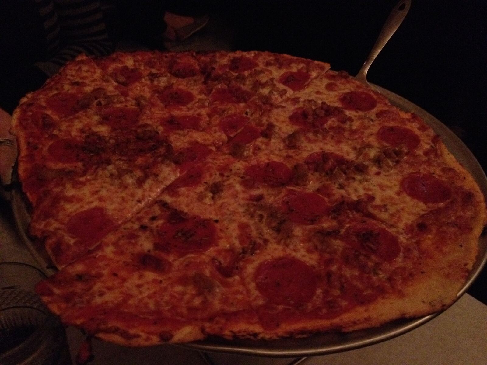 Sausage and pepperoni pizza on a round metal pan, Buona Vita Pizzeria