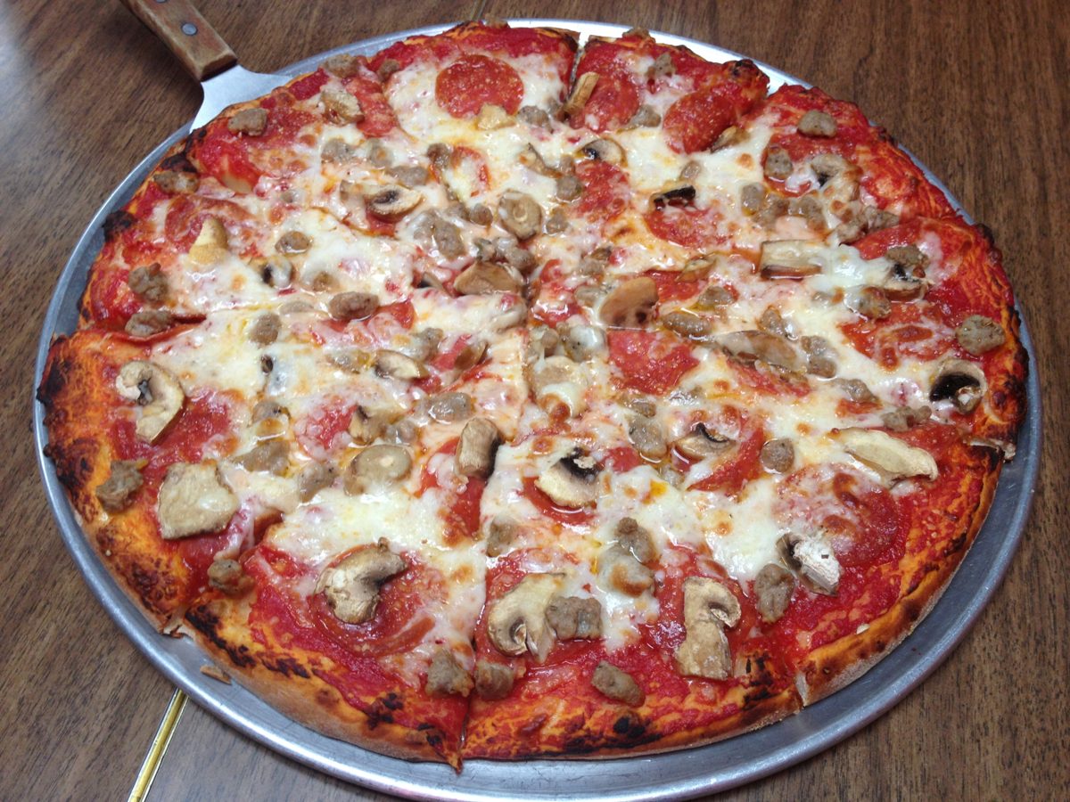 pepperoni, sausage, and mushroom pie on a serving pan, Comet’s Pizza