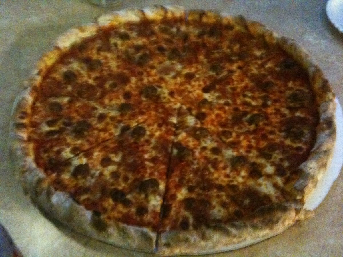 well-done pepperoni pie with deeply charred spots, Cosmic Pizza