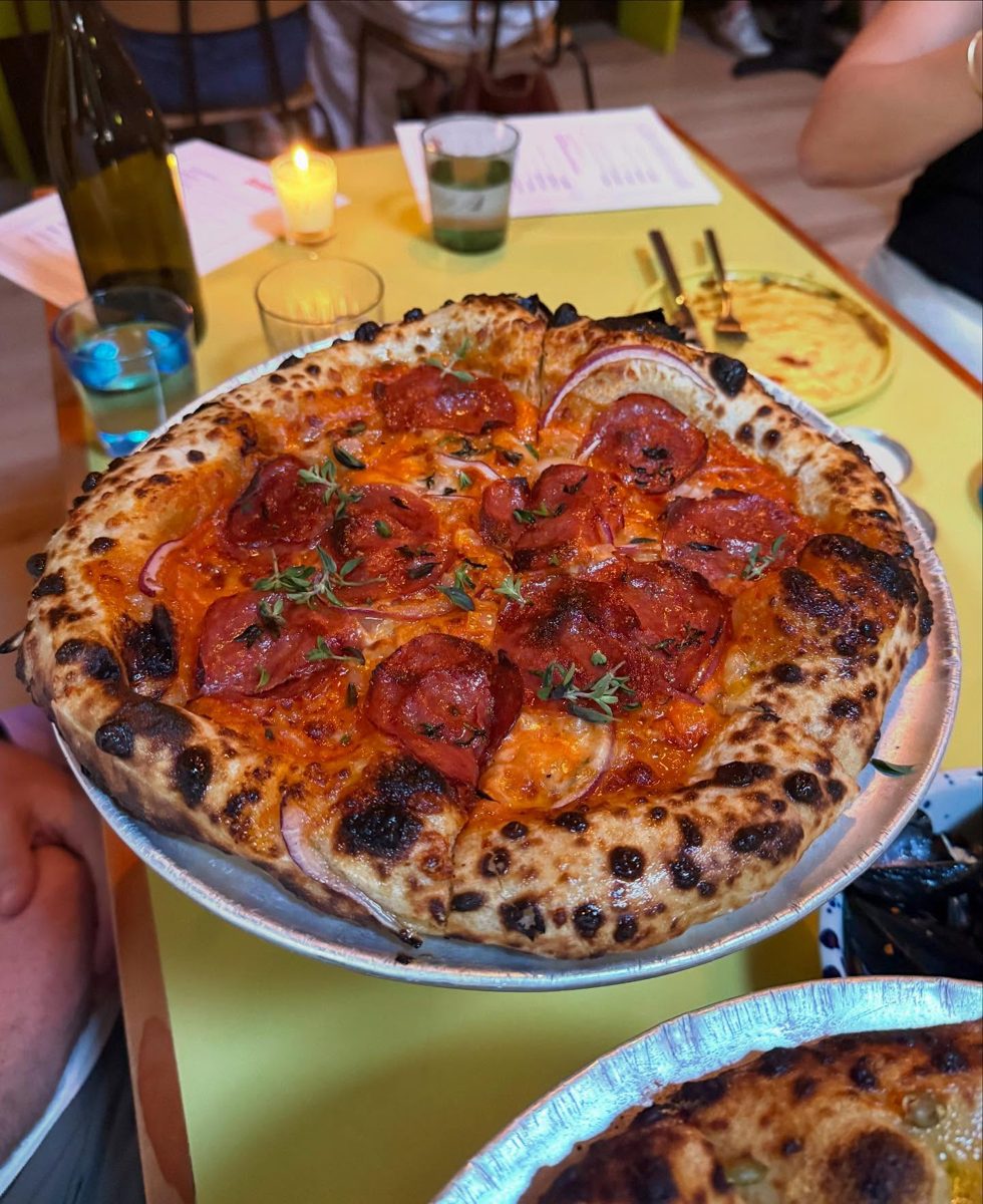 Blistered, char-spotted pie topped with pepperoni and onion, June Bug