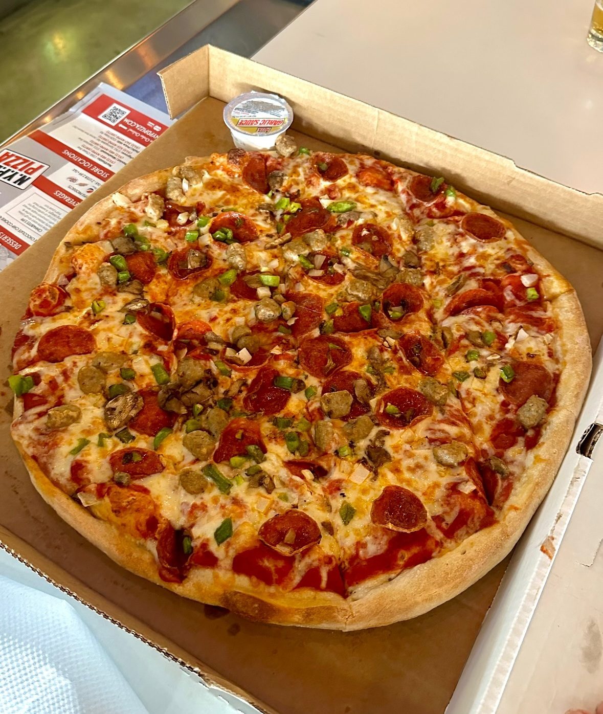 sunlit pepperoni slice with a charred crust edge, NYPD Pizza Delivery