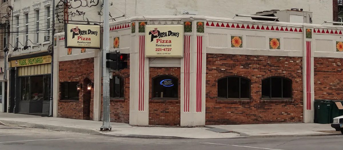 Papa Dino's Pizza Restaurant signs above the brick corner storefront on Calhoun Street, Papa Dino's