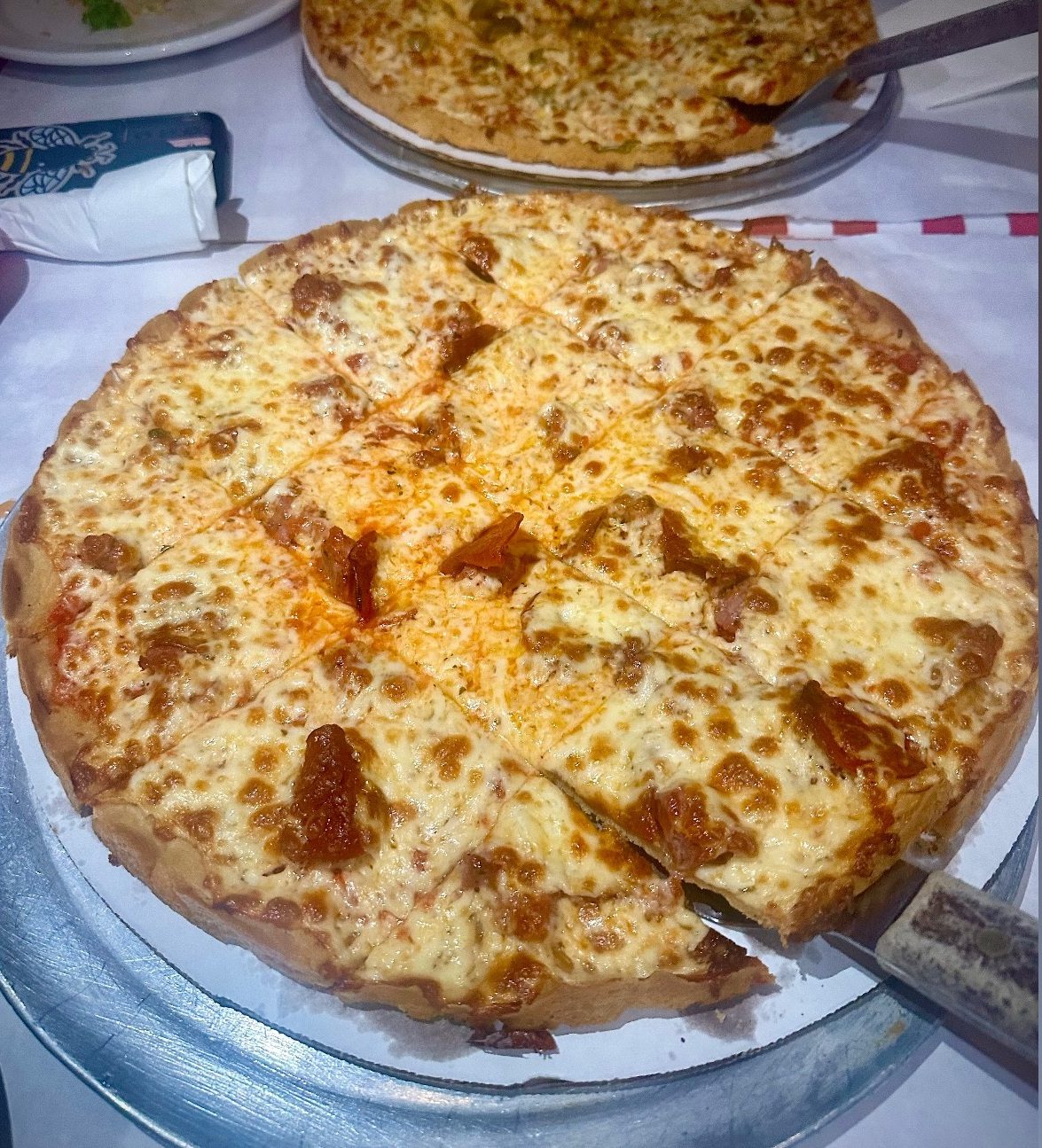 square-cut tavern pizza with a golden cheese blanket, Pizano's