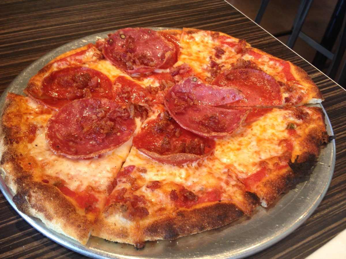 Char-flecked pie topped with large curled salami slices, Pizzelii Brick Oven Pizza