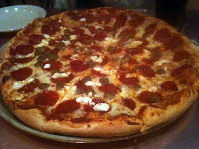 thin pie with pepperoni and dollops of white cheese, Pomodori’s