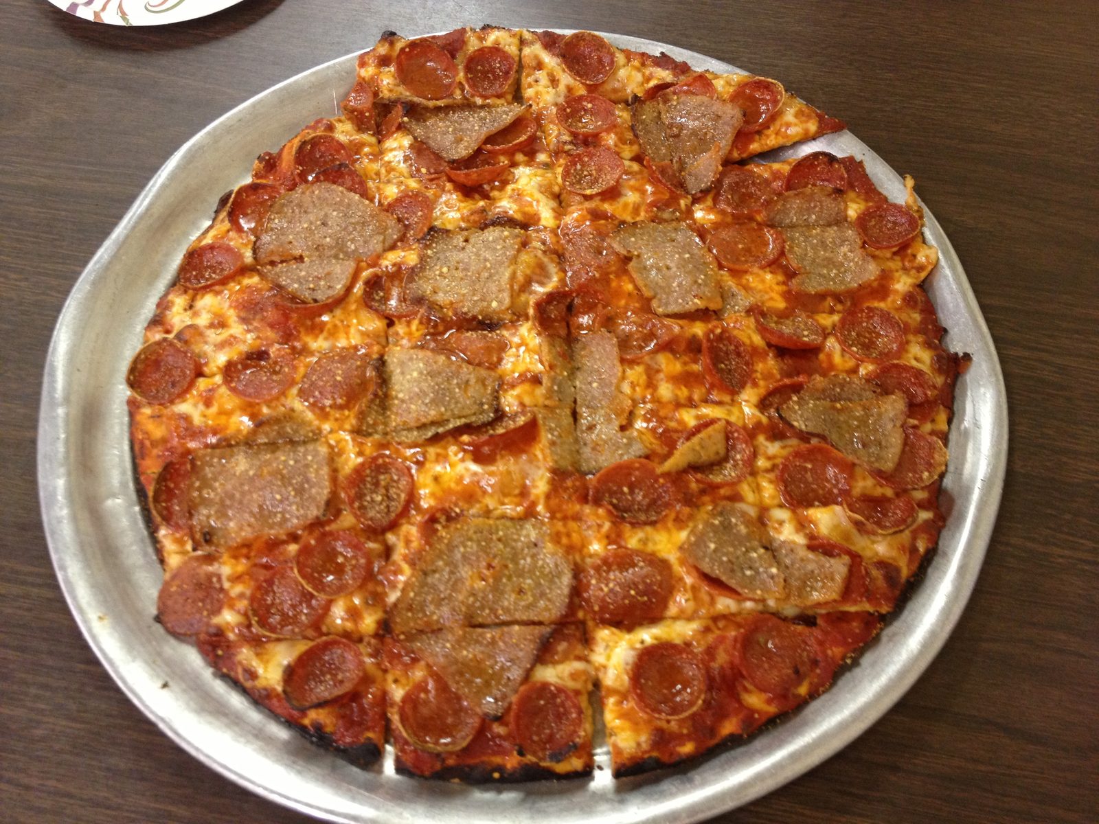 square-cut pepperoni pie with irregular pale topping chunks, Rubinos