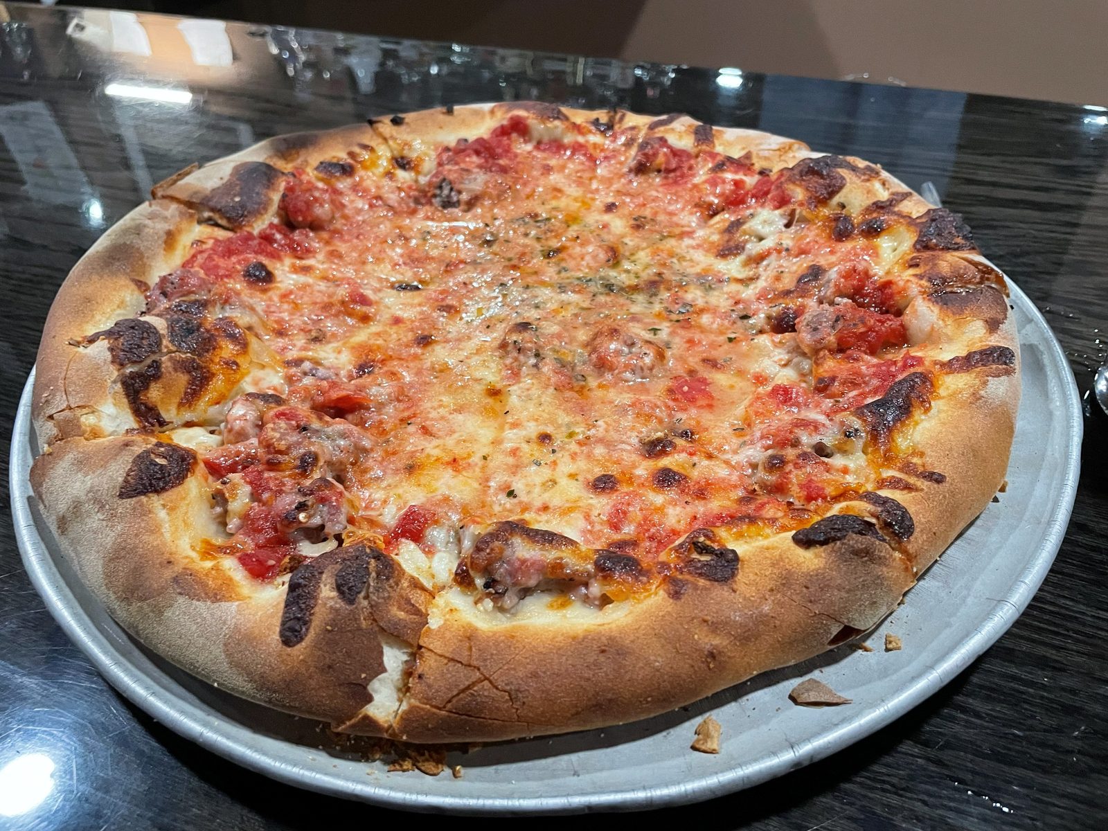 Crumbled sausage and pepperoni pizza on a kitchen counter, Santarpio's Pizza
