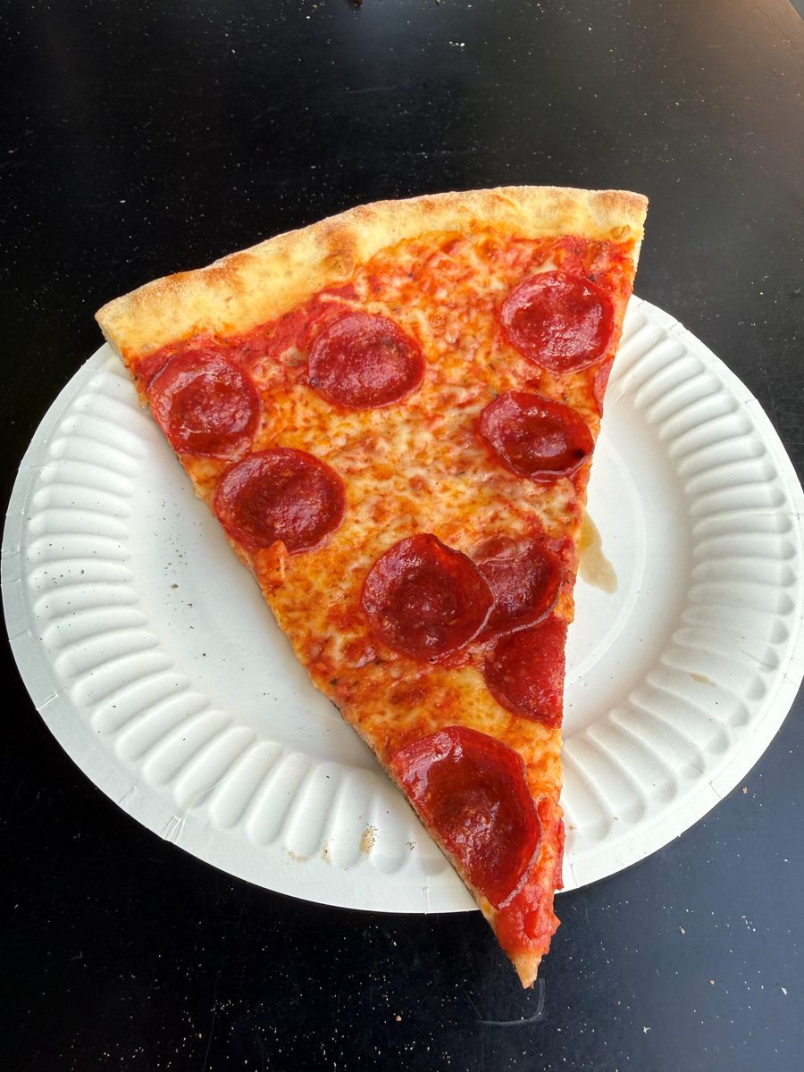 wide triangular pepperoni slice on a paper plate, East Village Pizza