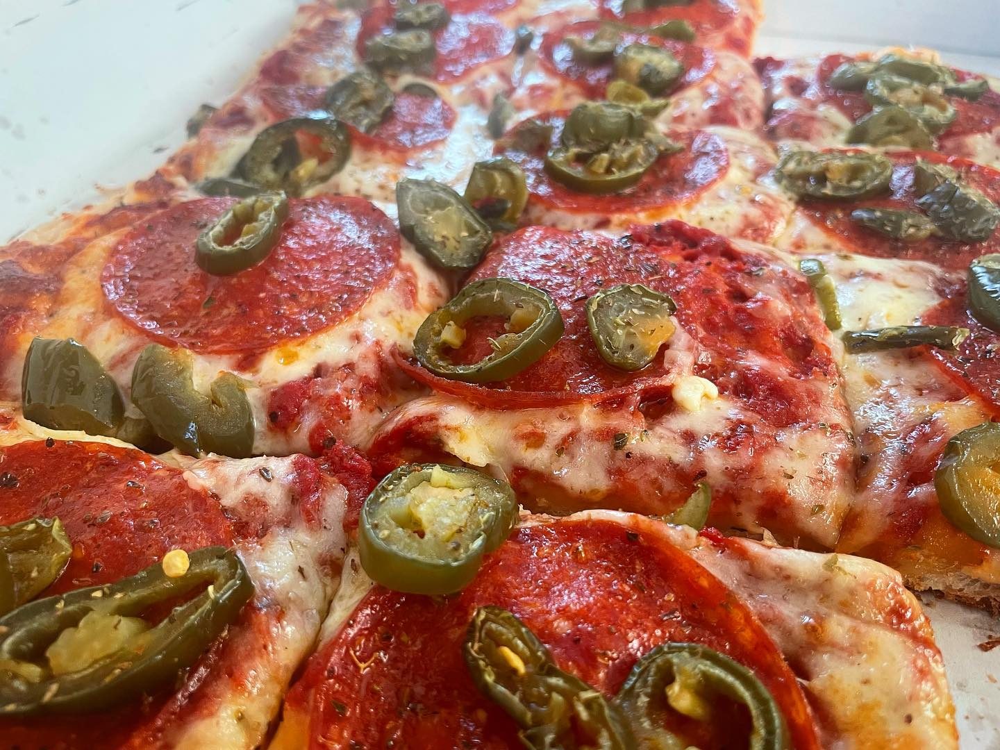 Close view of a pizza slice at Adriatico’s