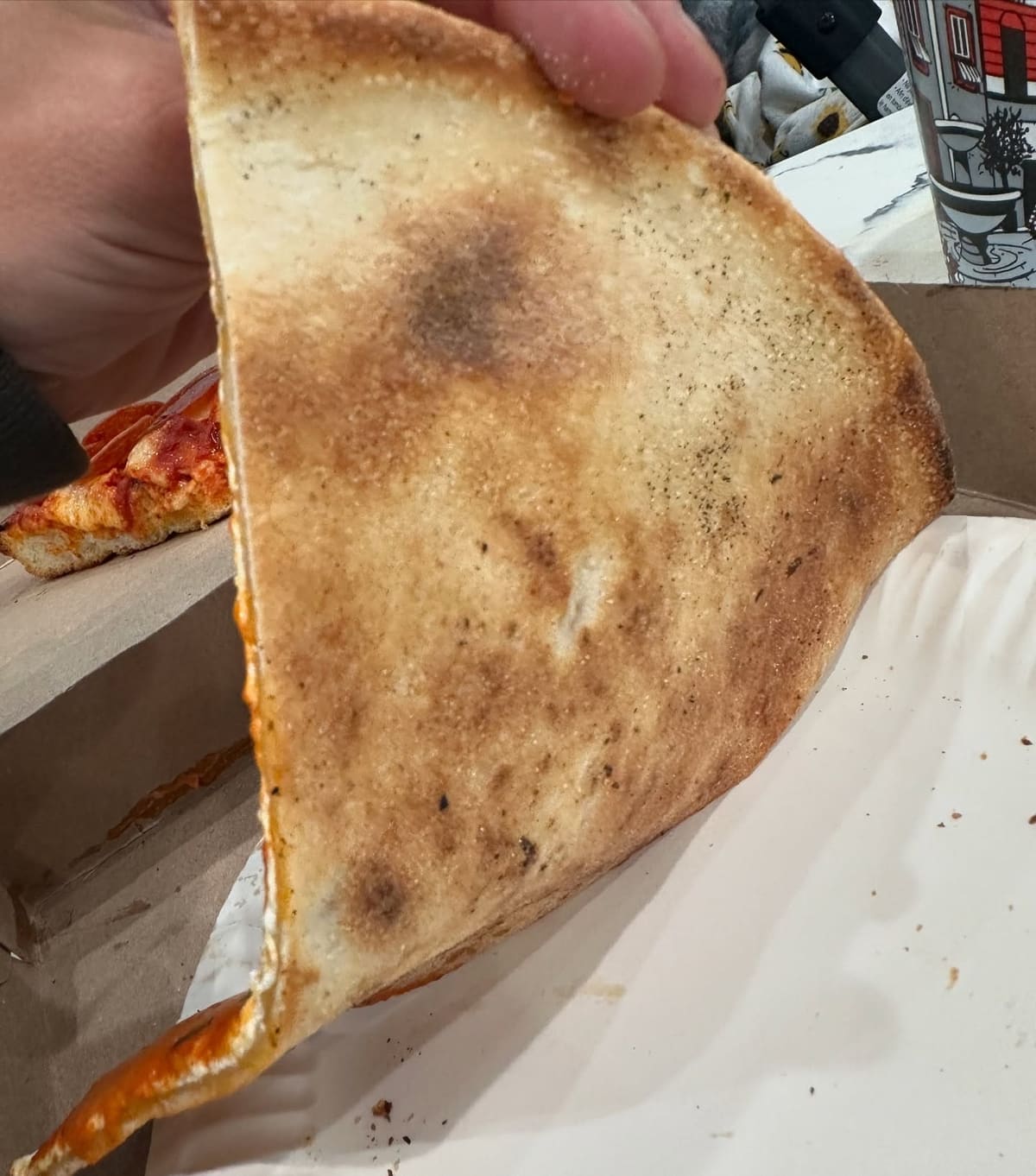 Underside of the pizza crust at Andiamo Pizza