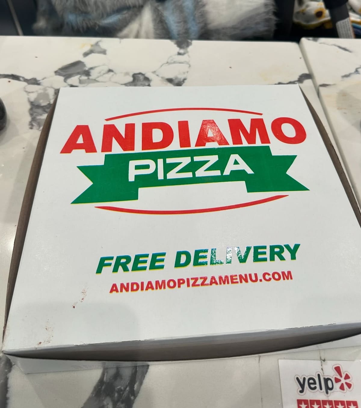 Restaurant sign at Andiamo Pizza