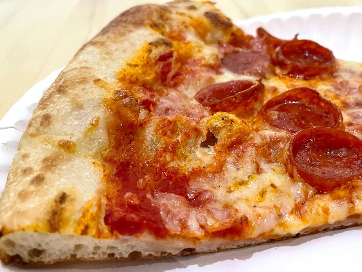 Close view of a pizza slice at Andy’s Pizza