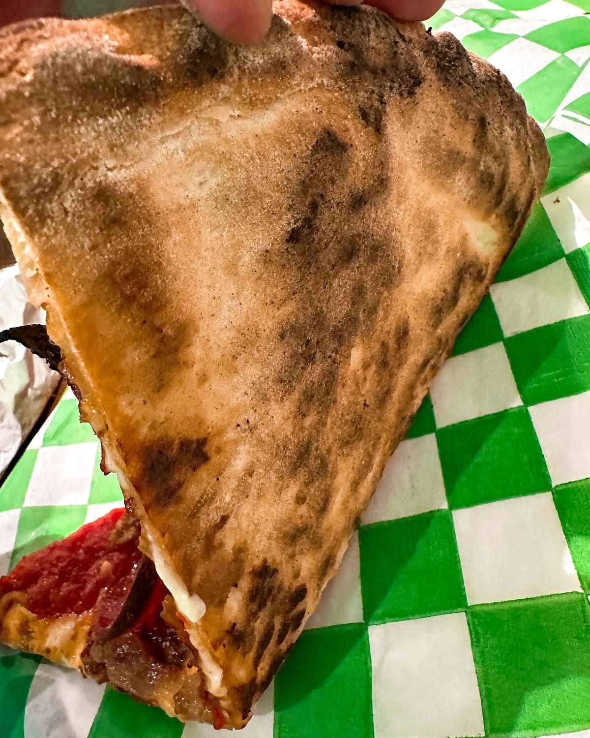 Underside of the pizza crust at Baked by Luigi