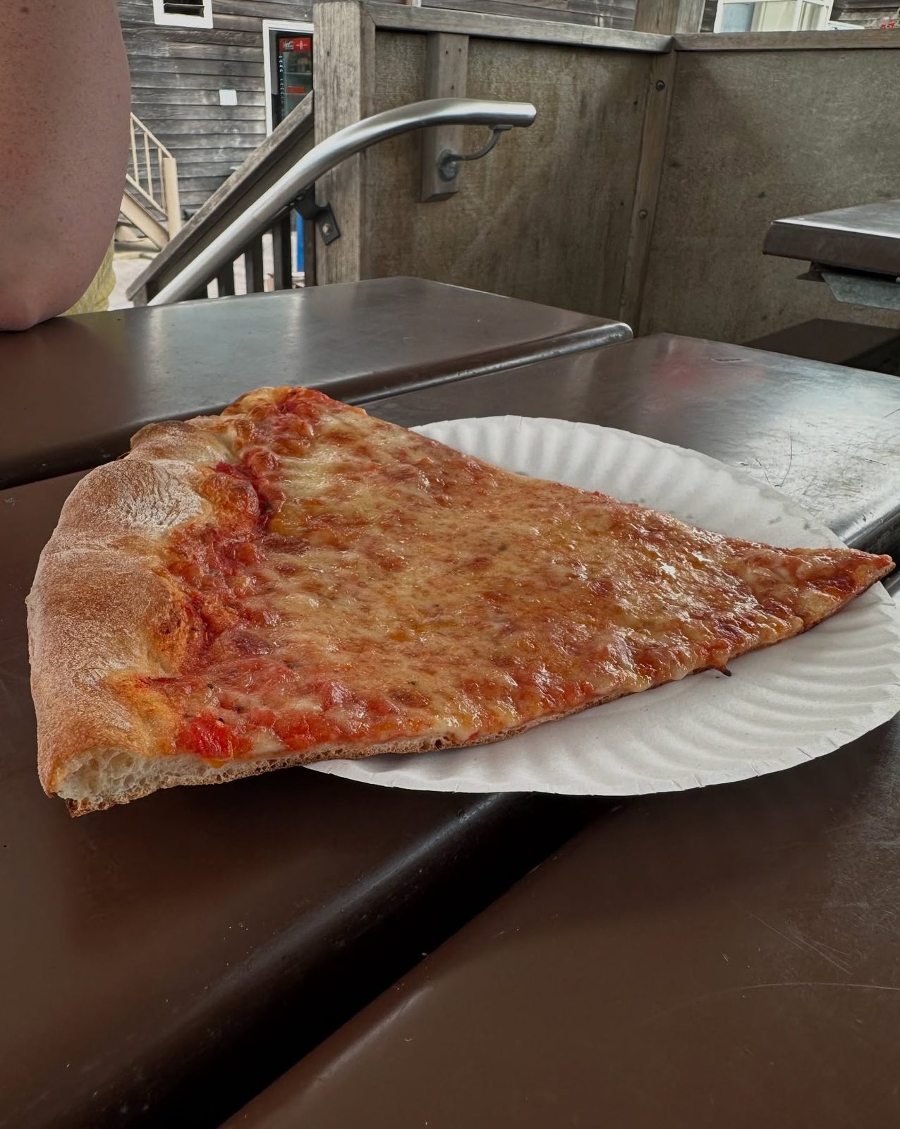 Close view of a pizza slice at Bay Village Pizza