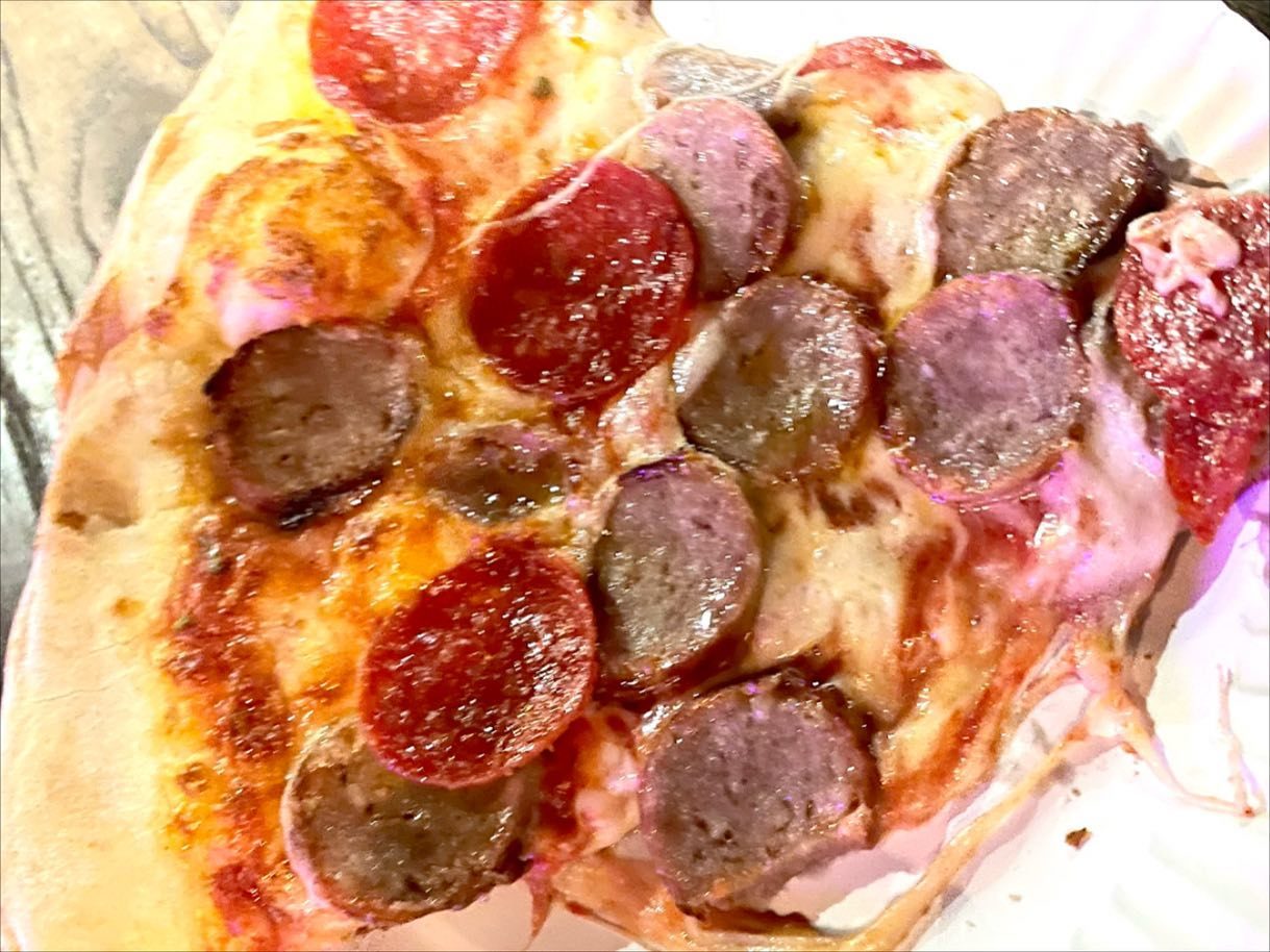 Close view of a pizza slice at Bleecker Street Pizza