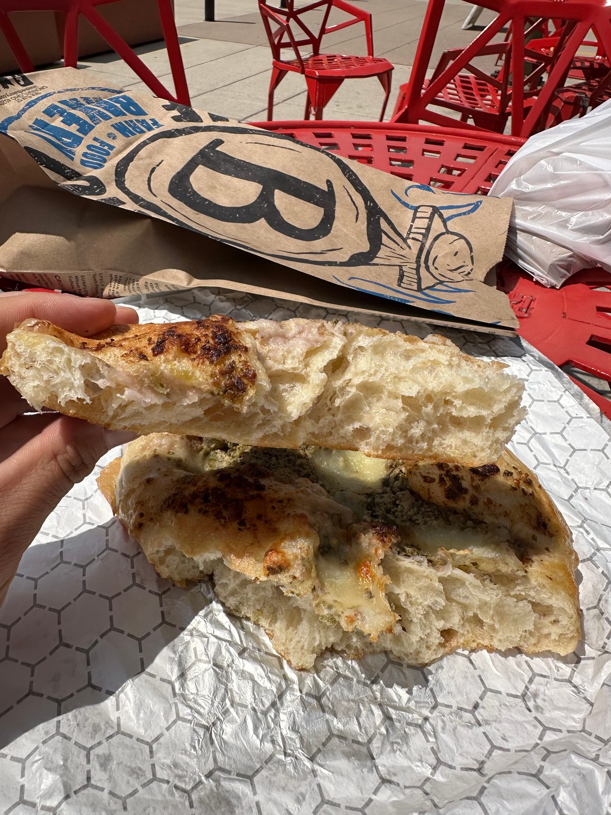 Focaccia torn open to show a pale, airy crumb full of large irregular holes, Blue Oven Bakery