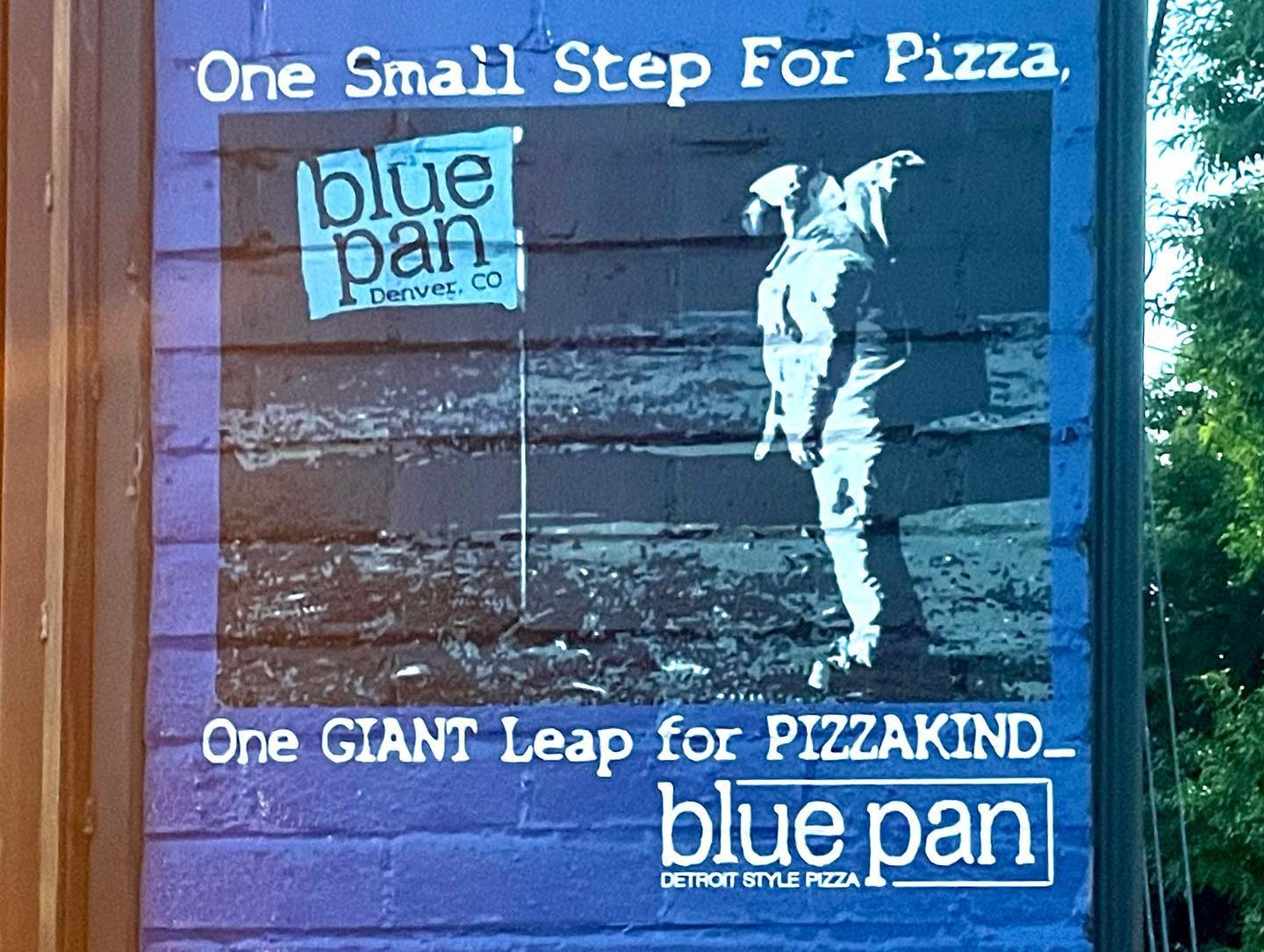 Sign reading One Small Step For Pizza at Blue Pan Pizza