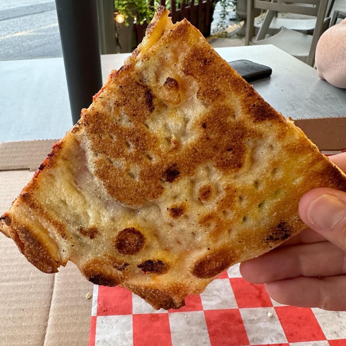 Underside of the pizza crust at Brazzi Wood-Fired Pizza & Trattoria
