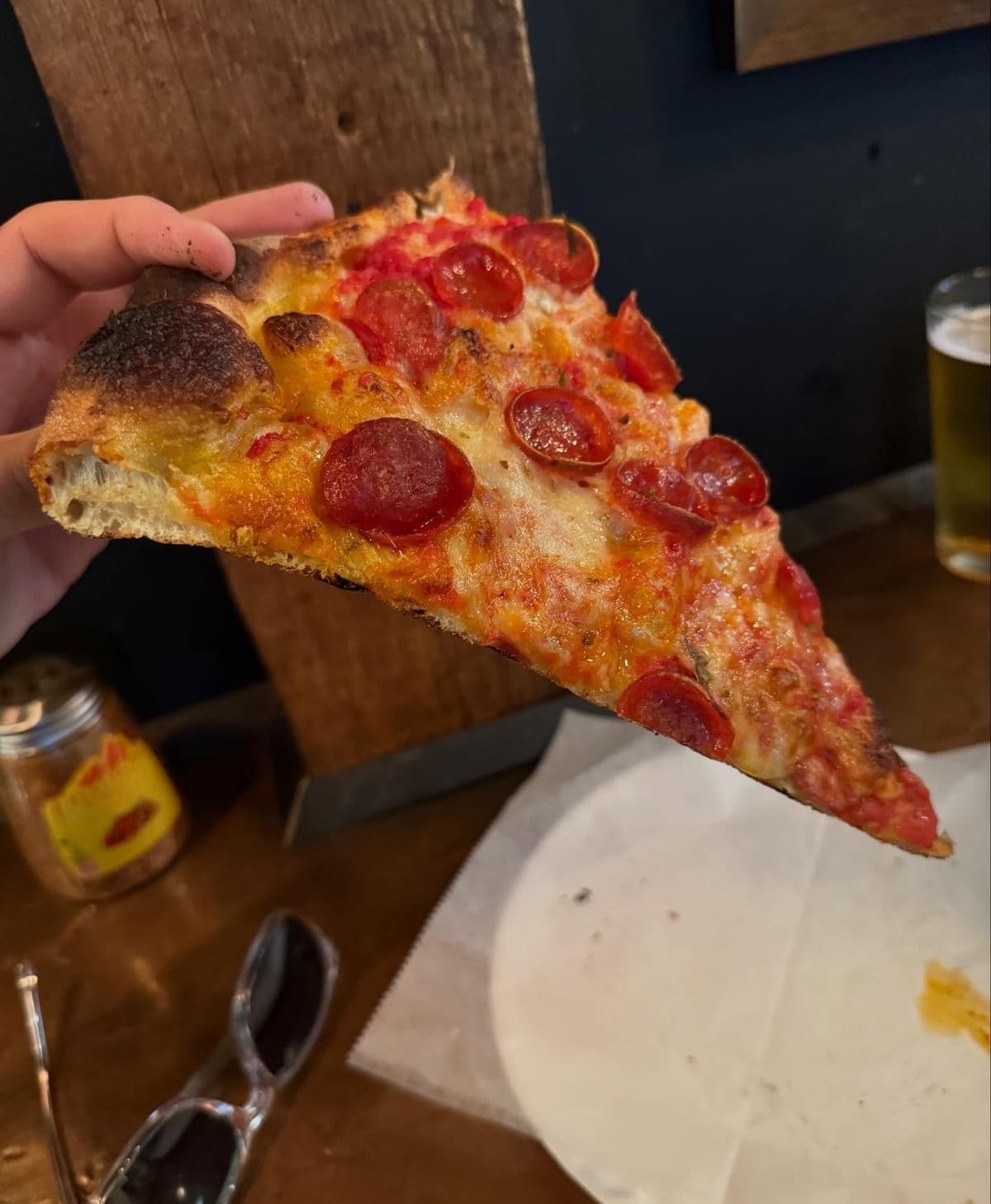 Pizza slice held up for a closer view at Brooklyn DOP in Park Slope