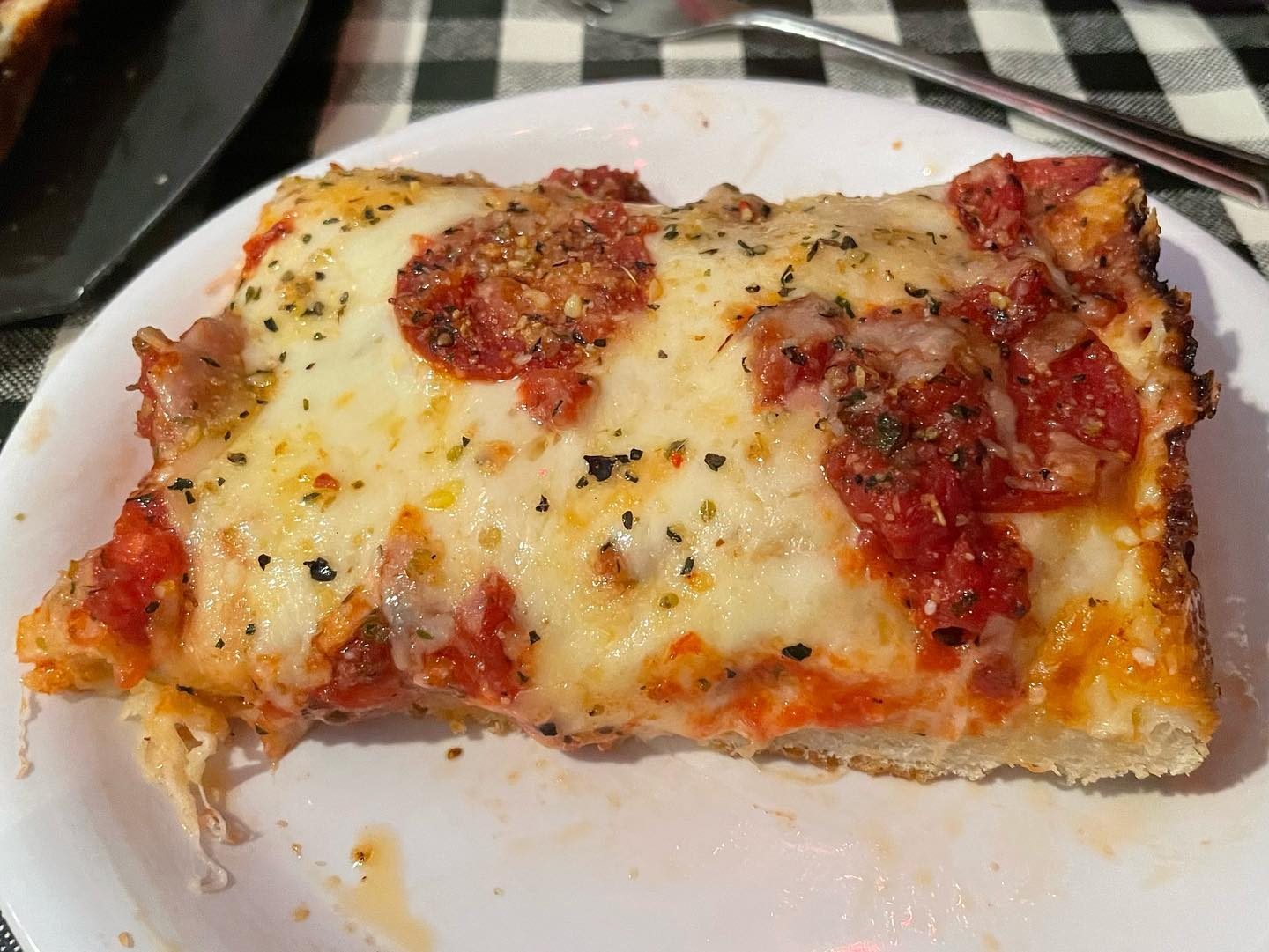 Square slice on a plate at Buddy’s Pizza