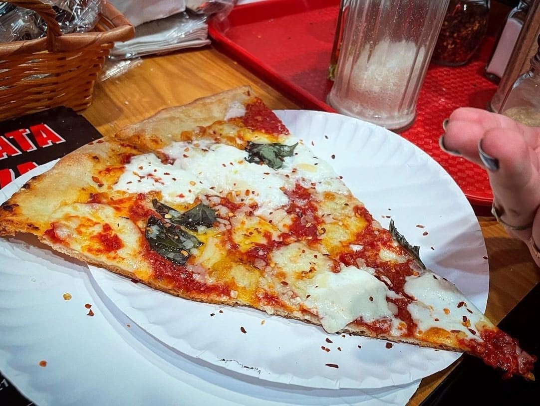 Close view of a pizza slice at Burrata Pizza