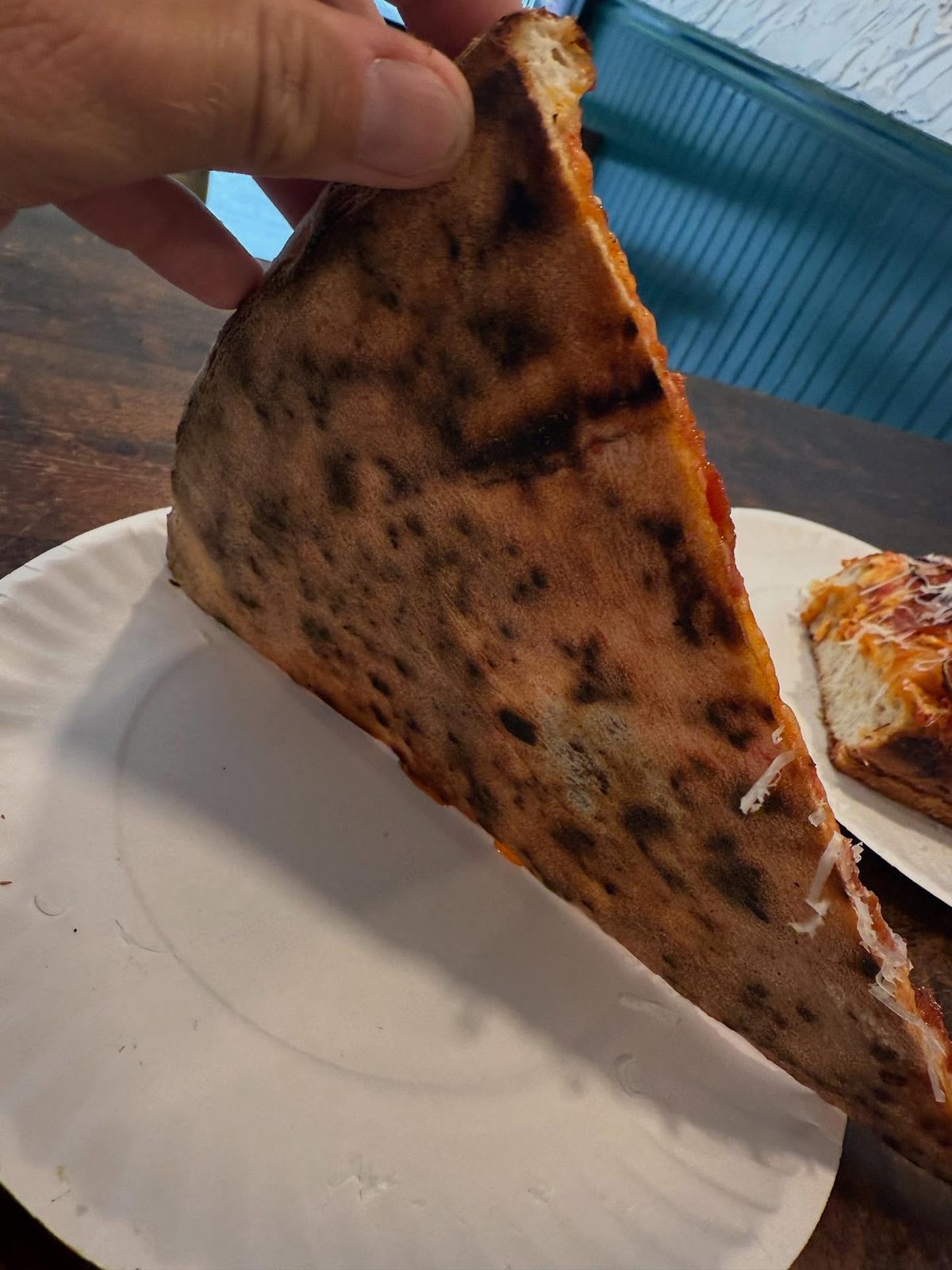 Underside of the pizza crust at Cello’s Pizzeria