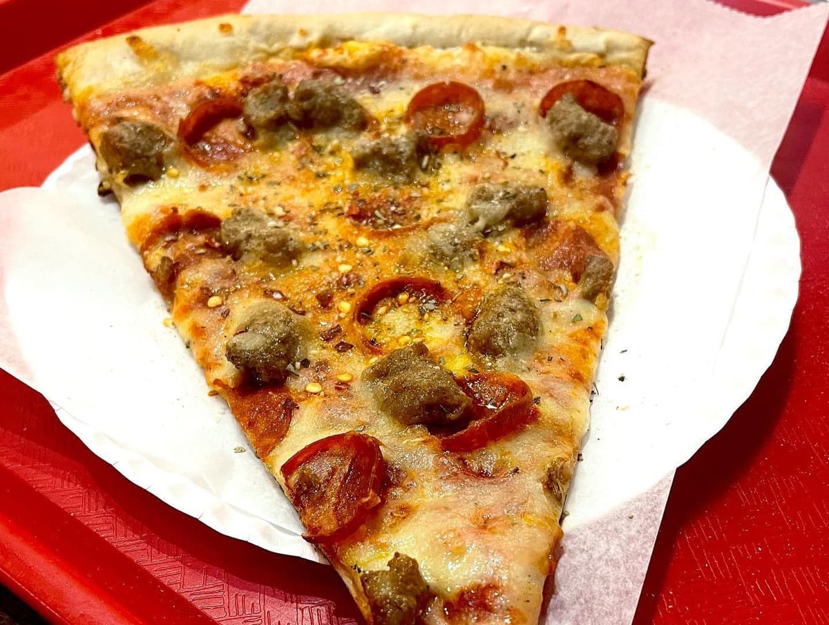 Close view of a pizza slice at Champion Pizza