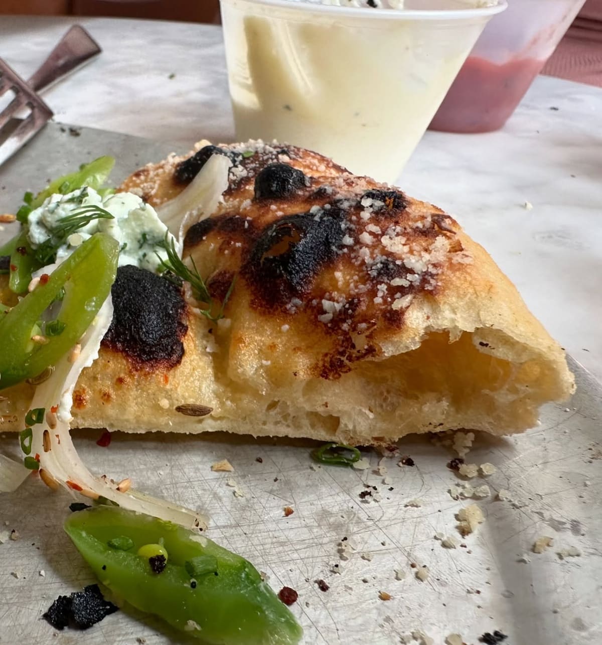 Close view of a pizza slice at Companion Pizza