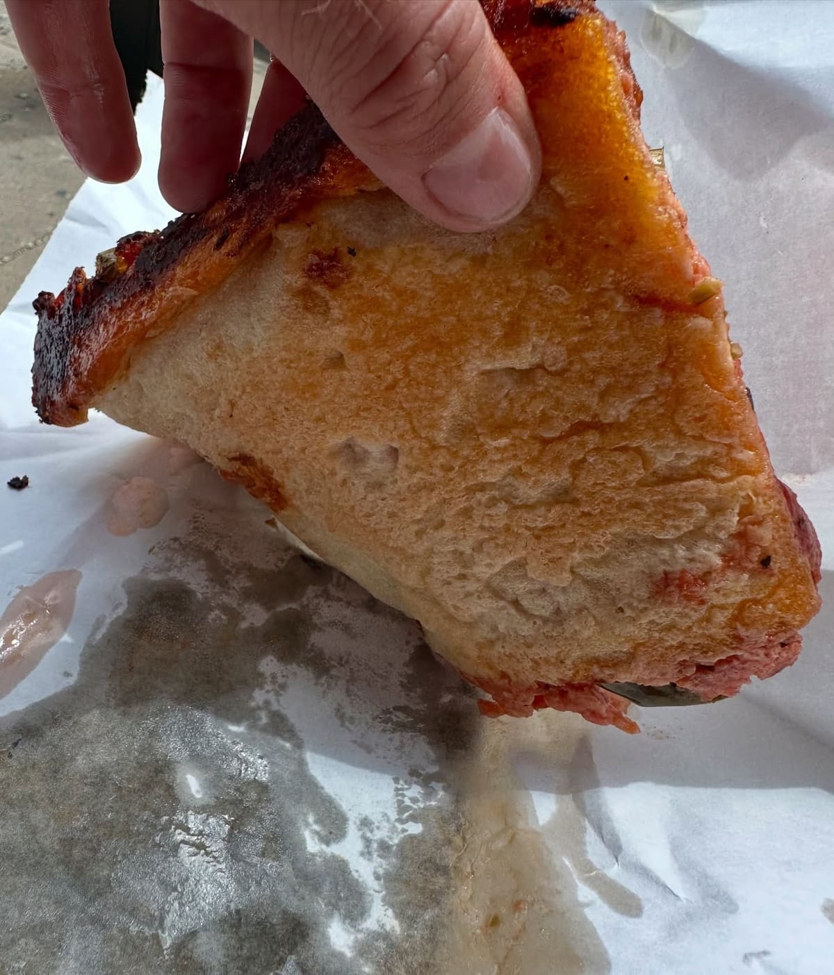Side profile of the pizza crust at D’Amato’s Bakery