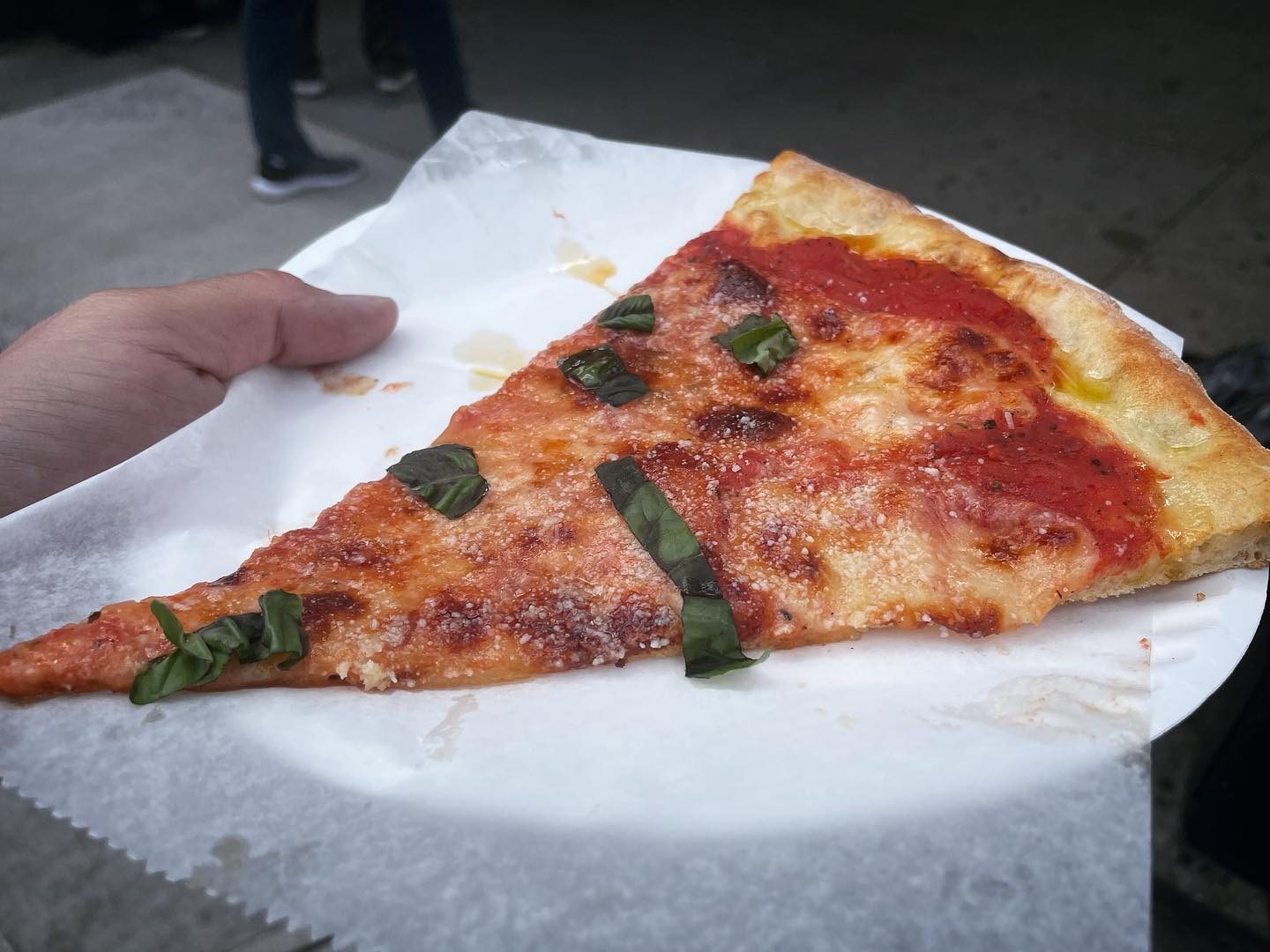 Plain slice with basil on a paper plate at Di Fara Pizza