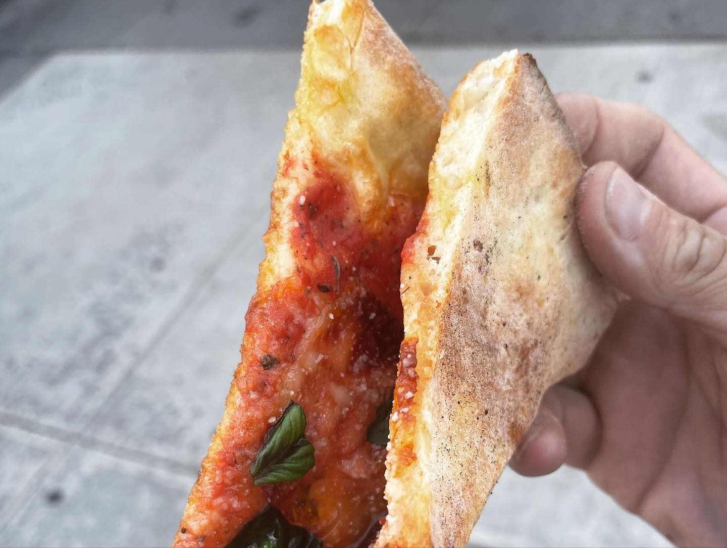 Slice folded to show the crust at Di Fara Pizza