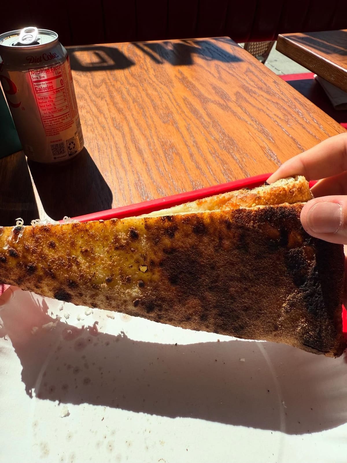 Side profile of the pizza crust at Diamond Slice in Greenpoint