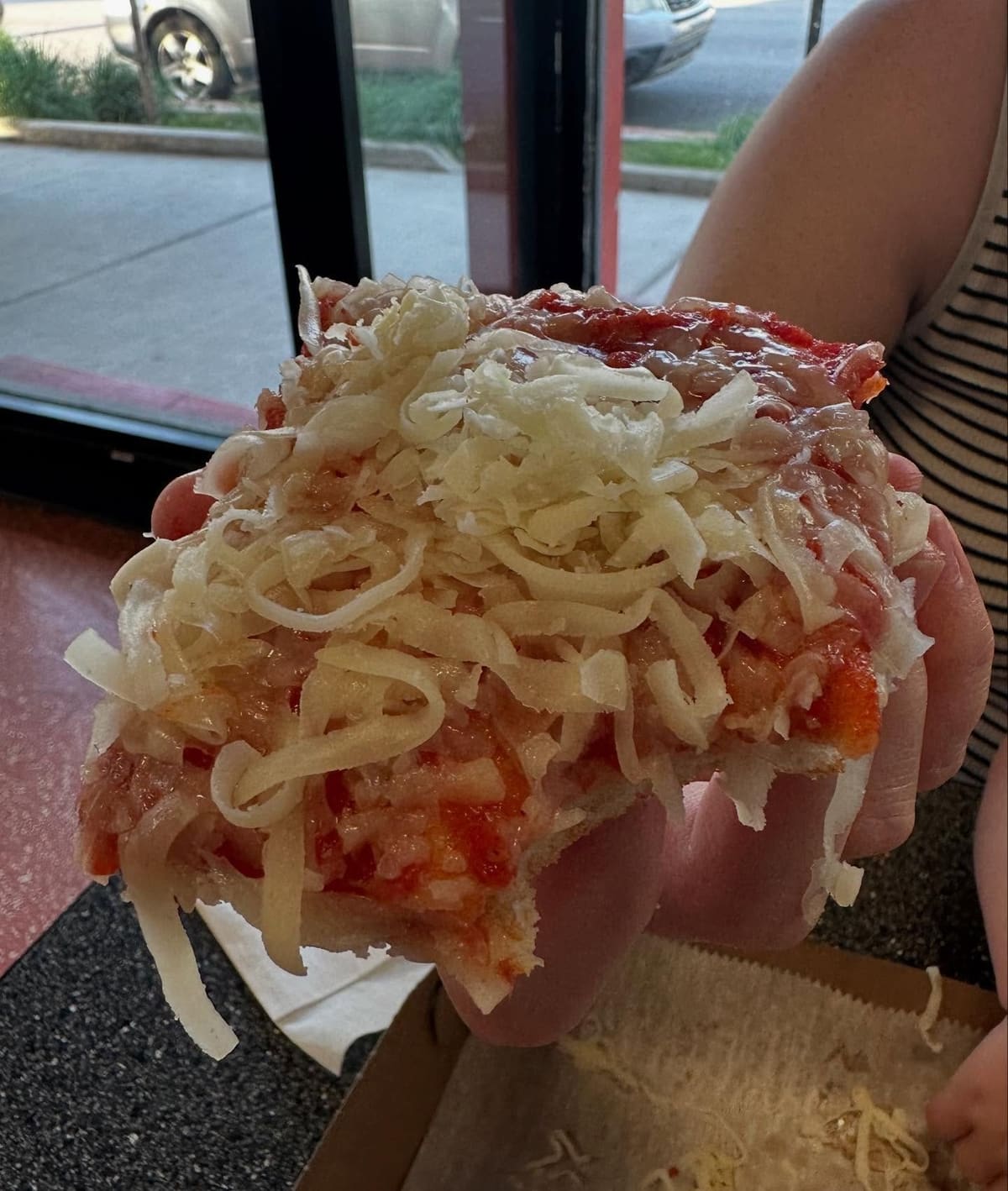 Pizza slice held up for a closer view at DiCarlo’s Original Pizza in Wheeling, WV