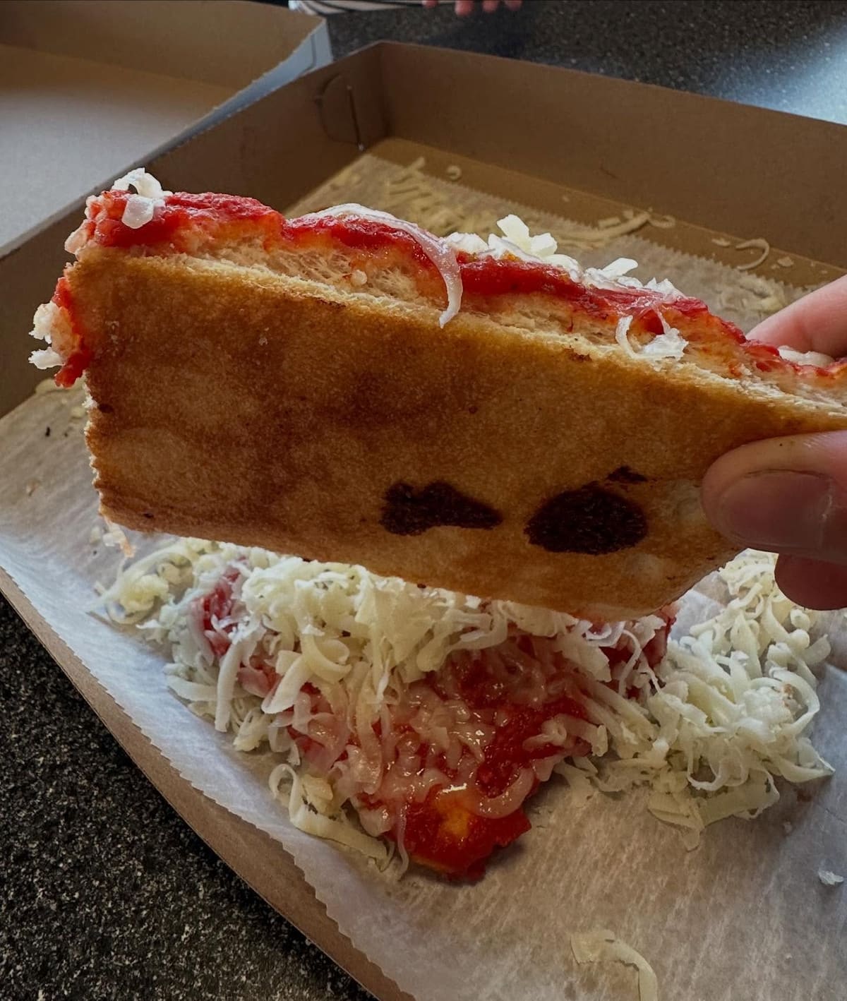 Side profile of the pizza crust at DiCarlo’s Original Pizza in Wheeling, WV