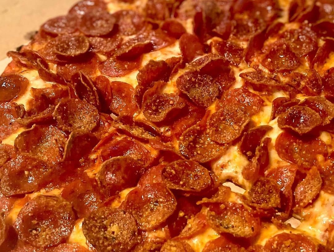 Close view of a pizza slice at Donatos