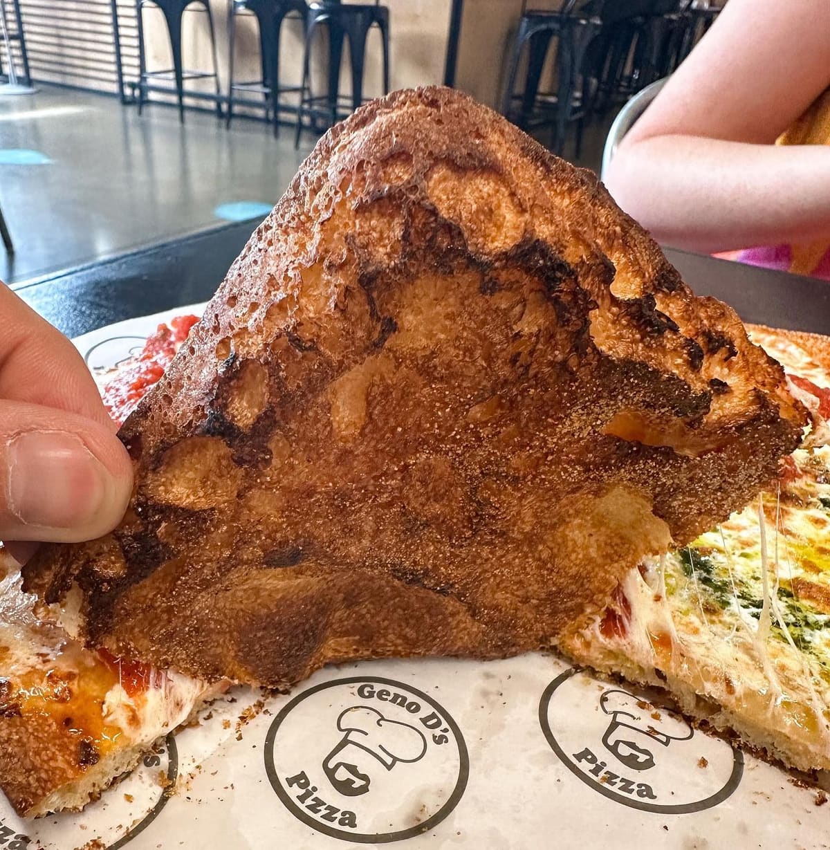 Underside of the pizza crust at Geno D's Pizza