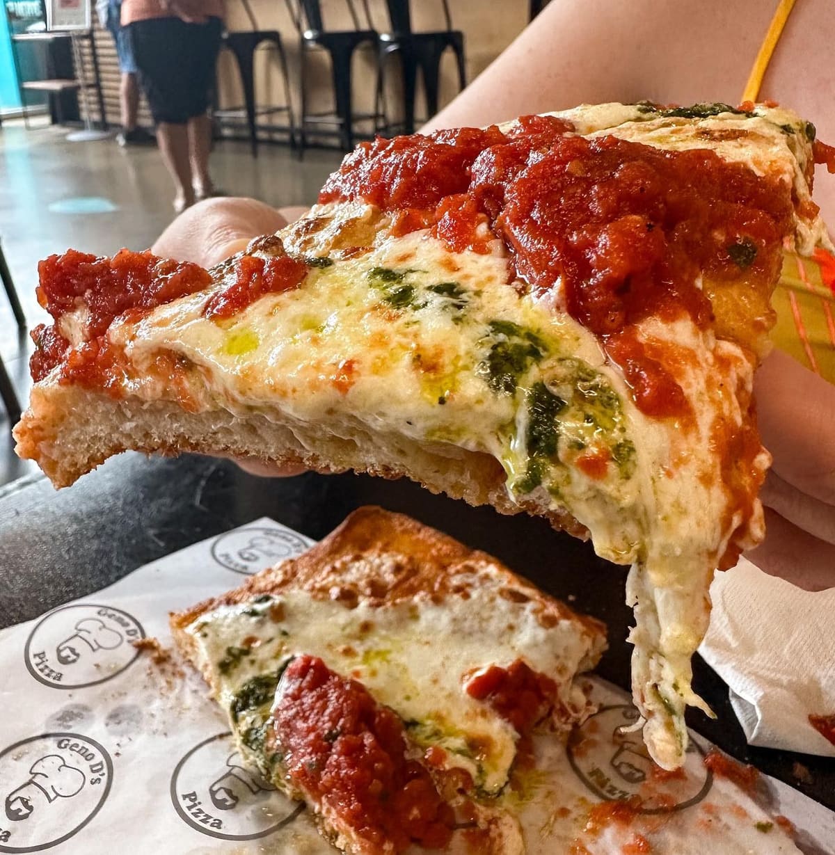 Pizza slice being lifted at Geno D's Pizza