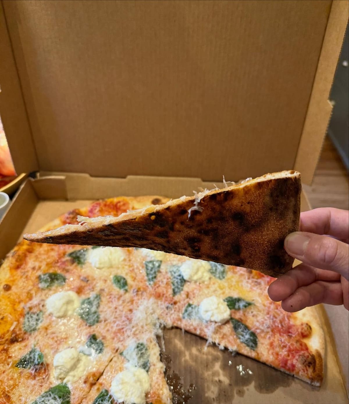 Pizza slice being lifted from the pie at Guardia Pizza in Mt Lookout