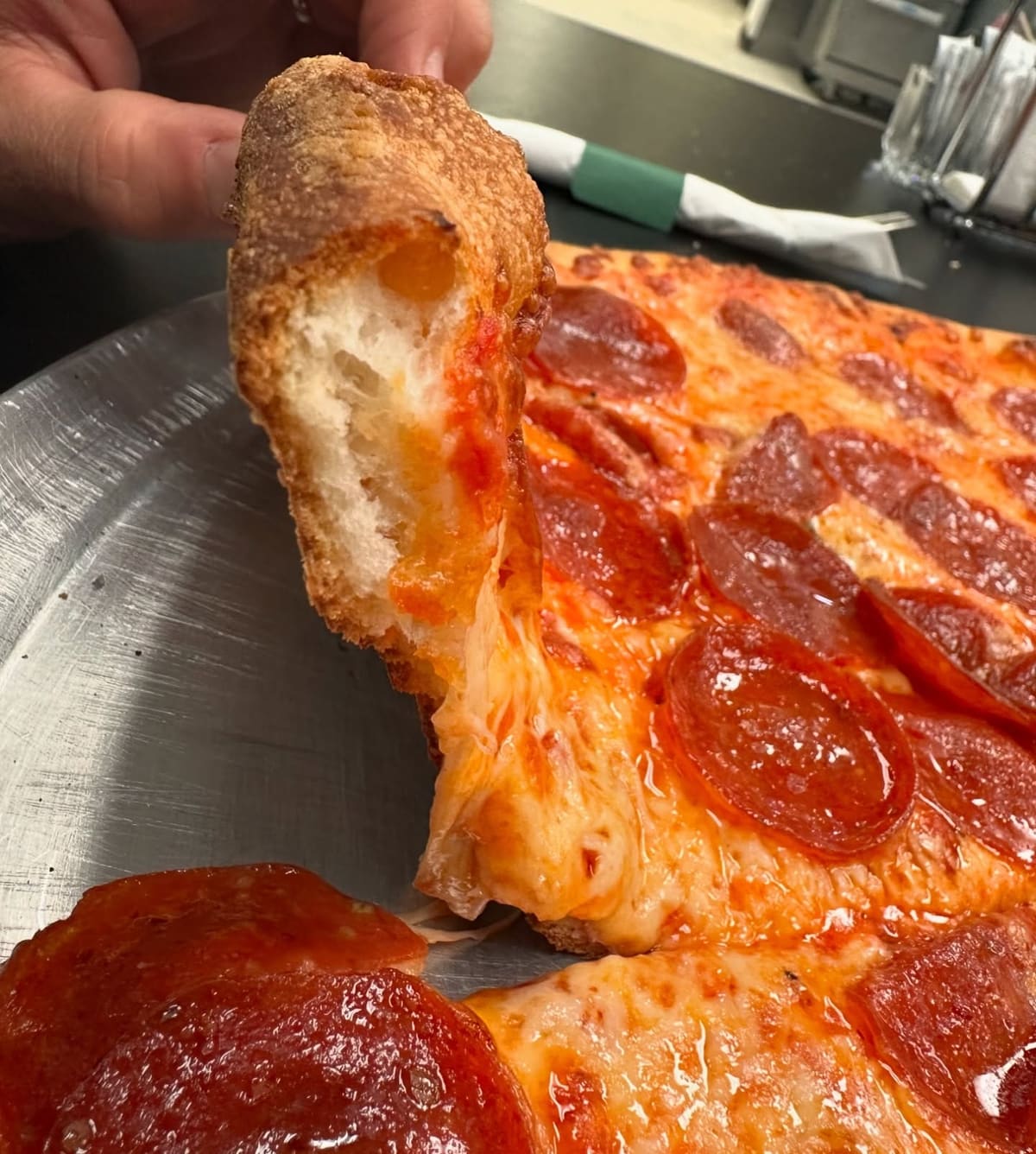 Pizza slice with melted cheese at Il Gusto Pizza & Pasta
