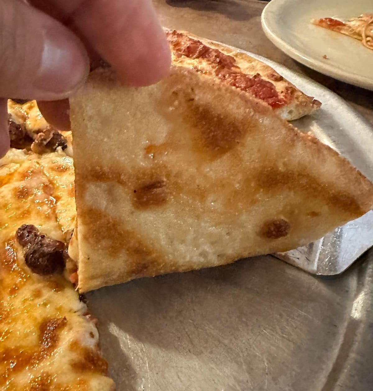 Underside of the pizza crust at Italianette Pizza