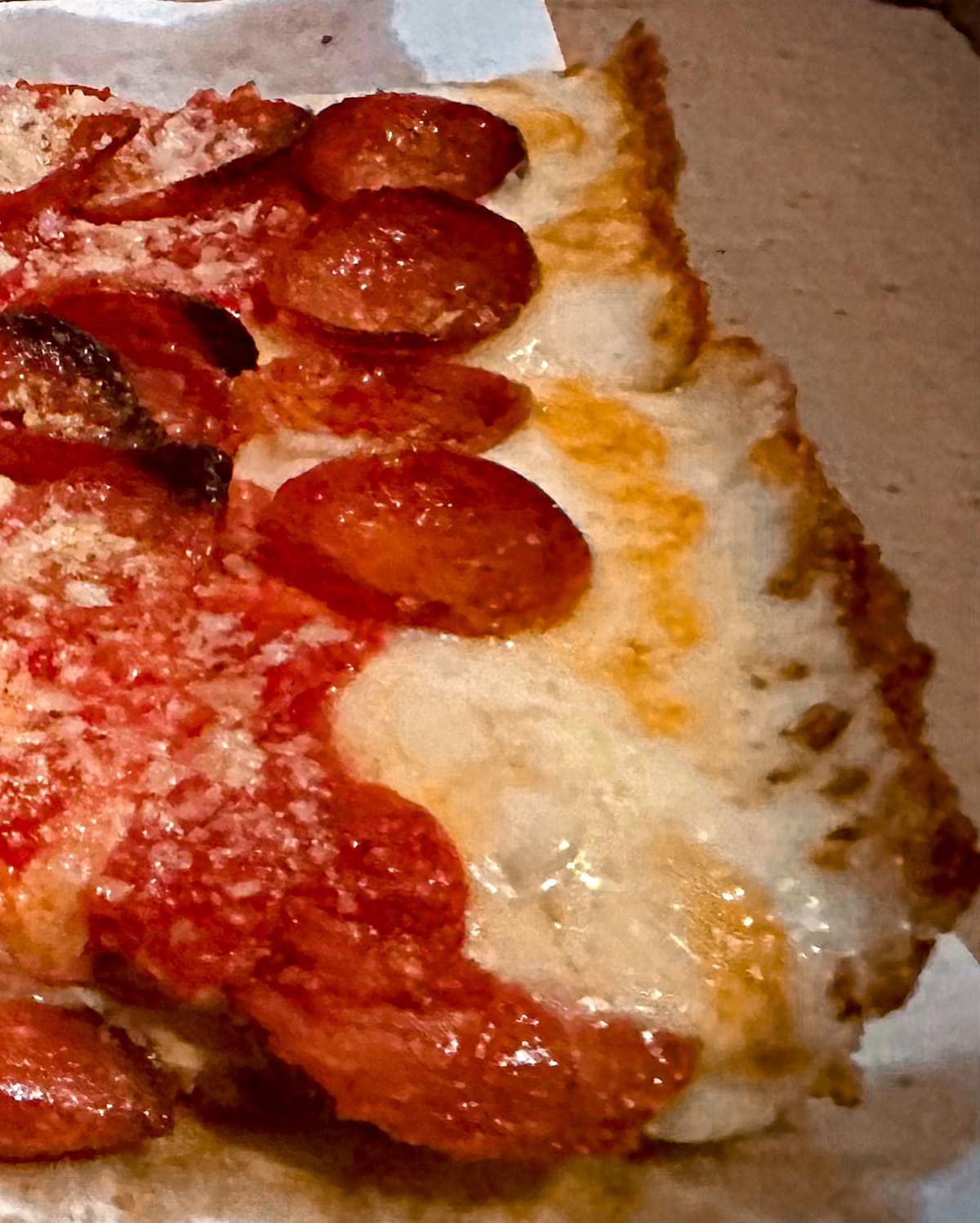 Close view of a pizza slice at Ivy & Coney