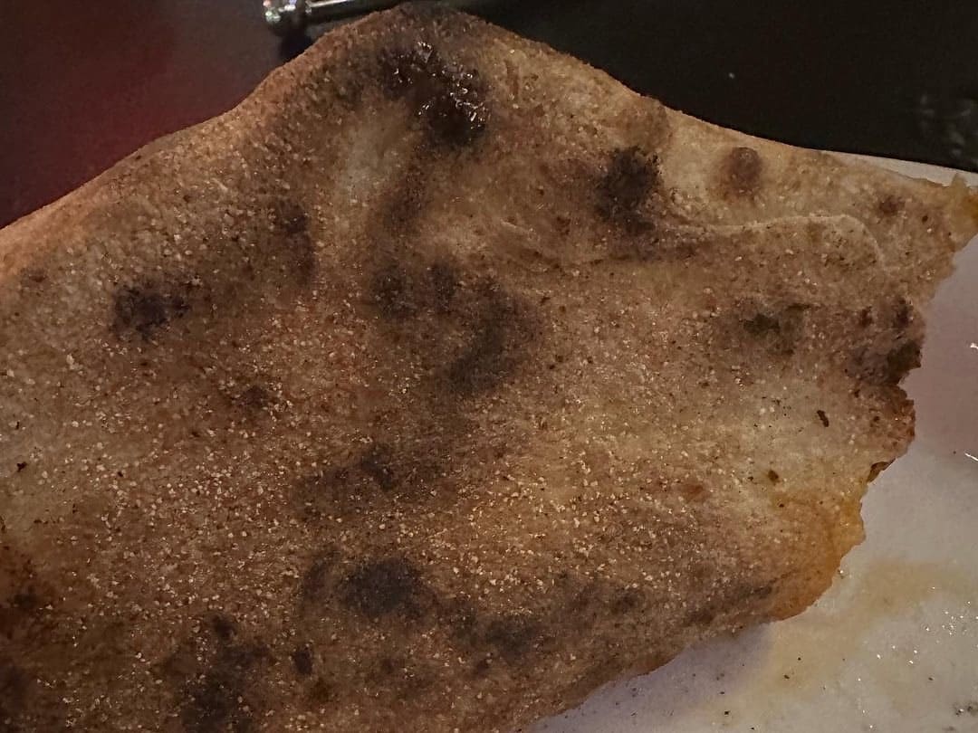 Underside of the pizza crust at Joe’s Pizza Napoli