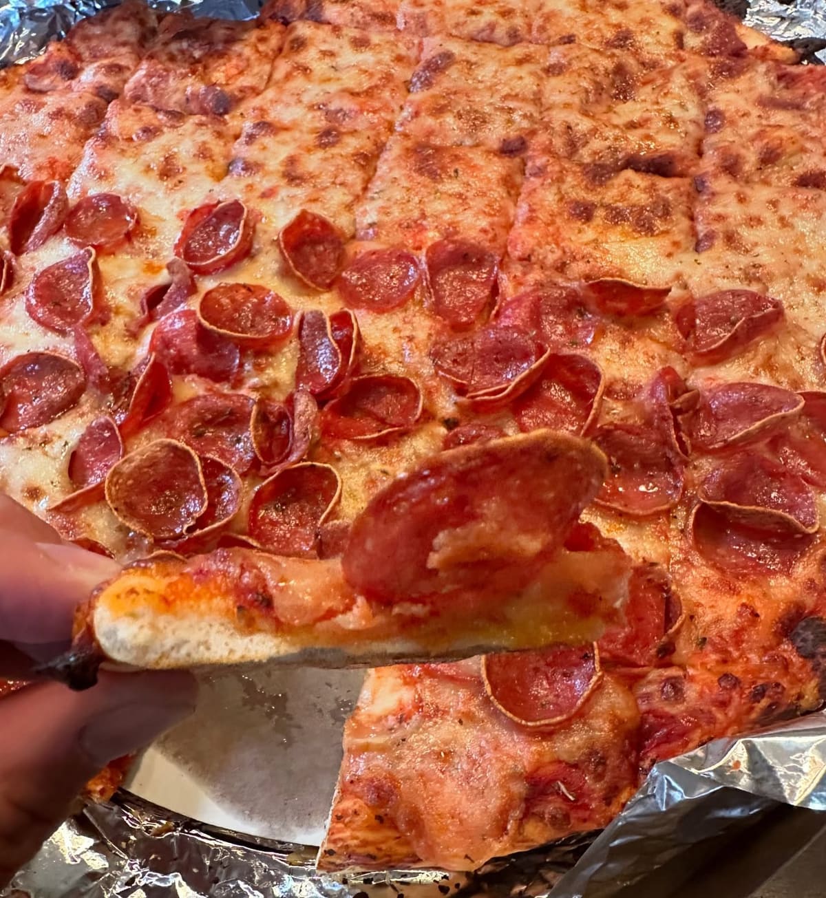Close view of a pizza slice at Joe’s Pizzeria