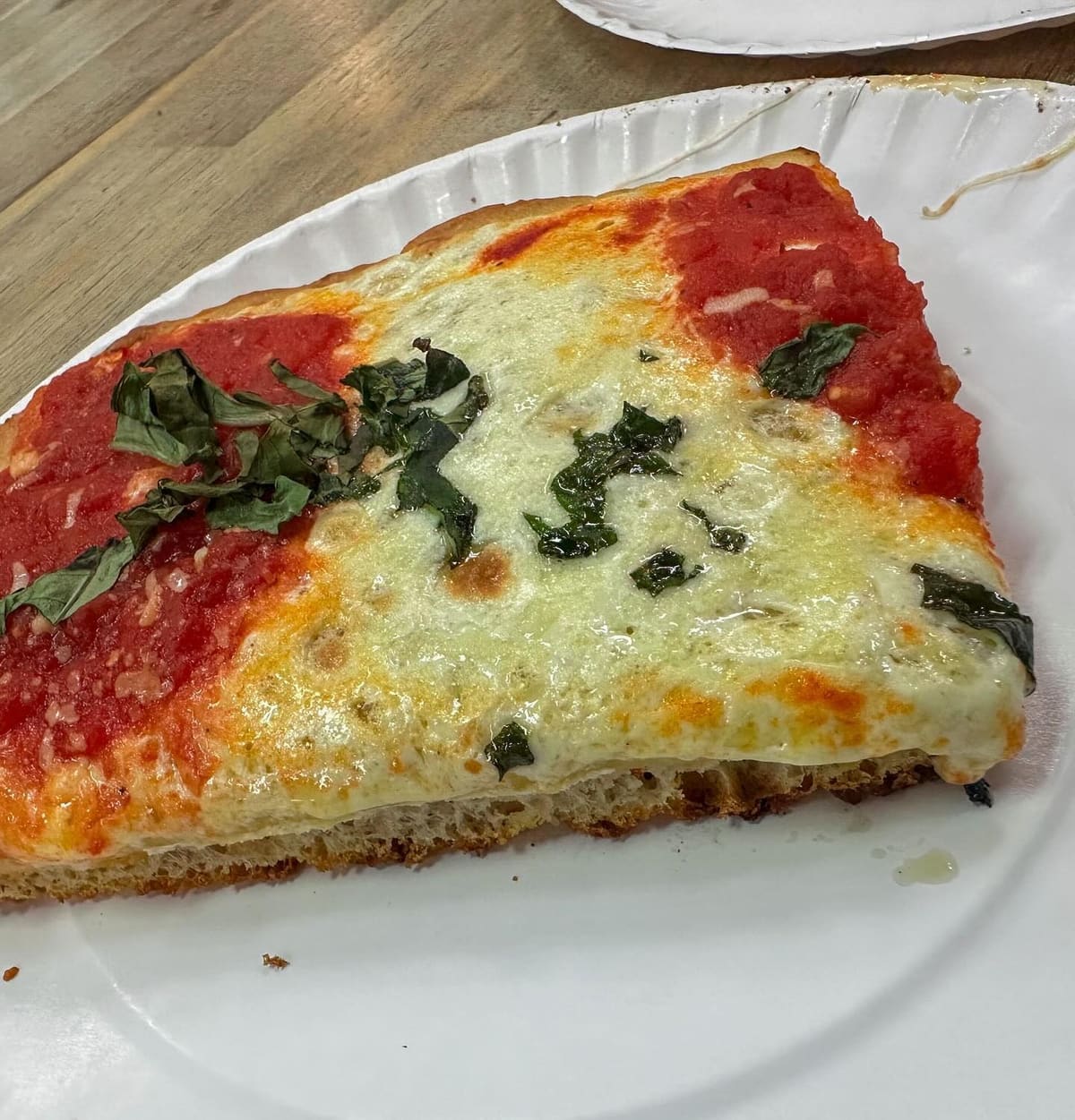 Side profile of a pizza slice at Krispy Pizza
