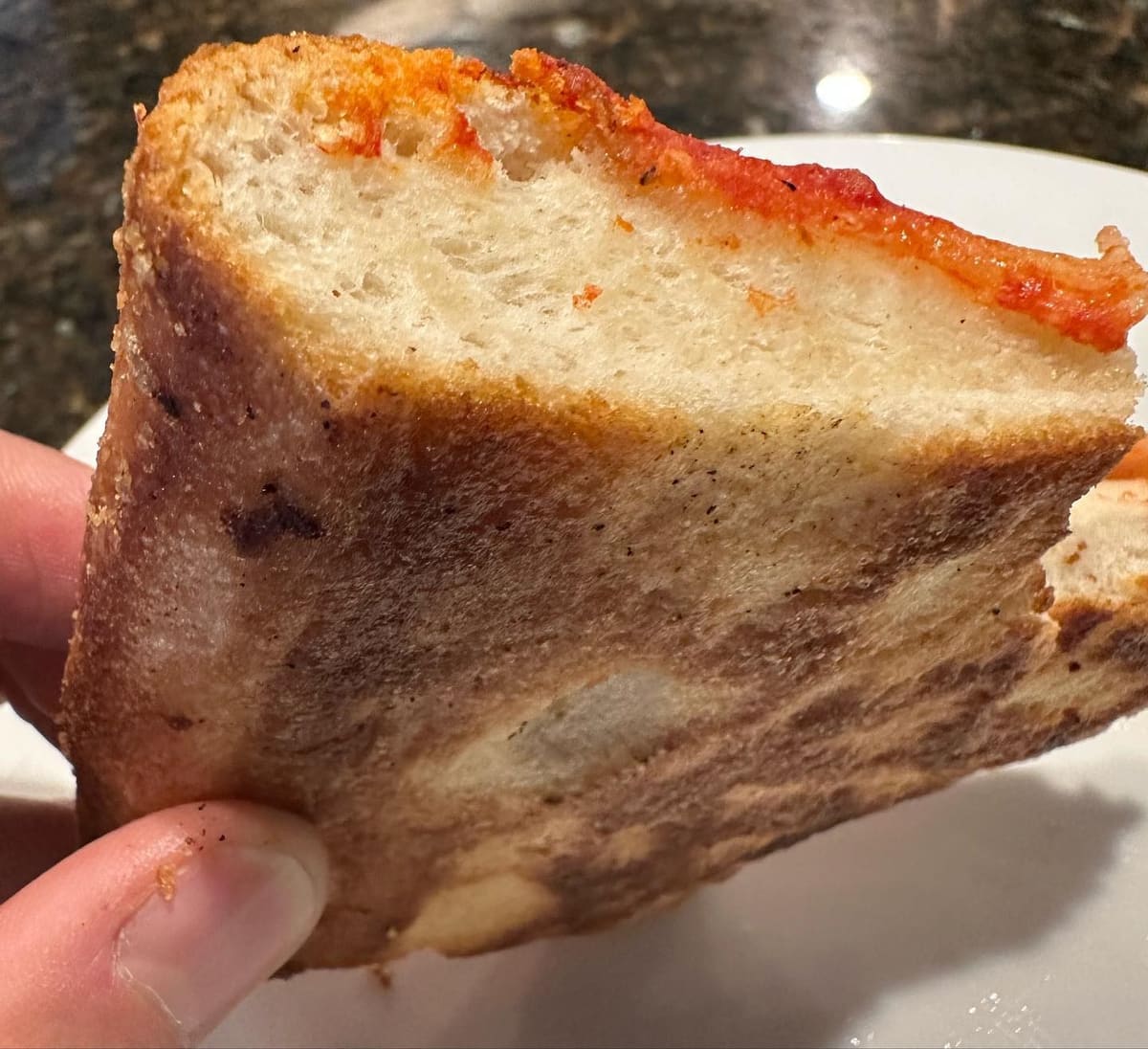 Side profile of the pizza crust at L&B Spumoni Gardens