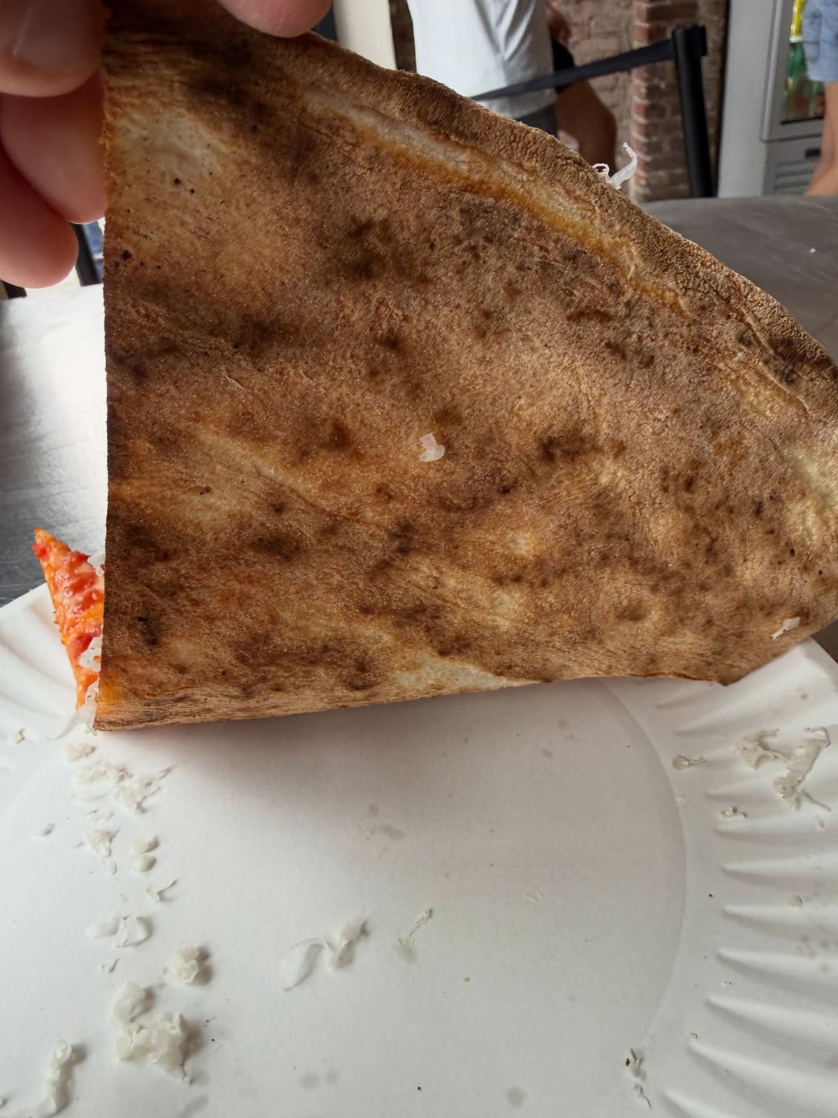 Underside of the pizza crust at L’Industrie in Little Italy