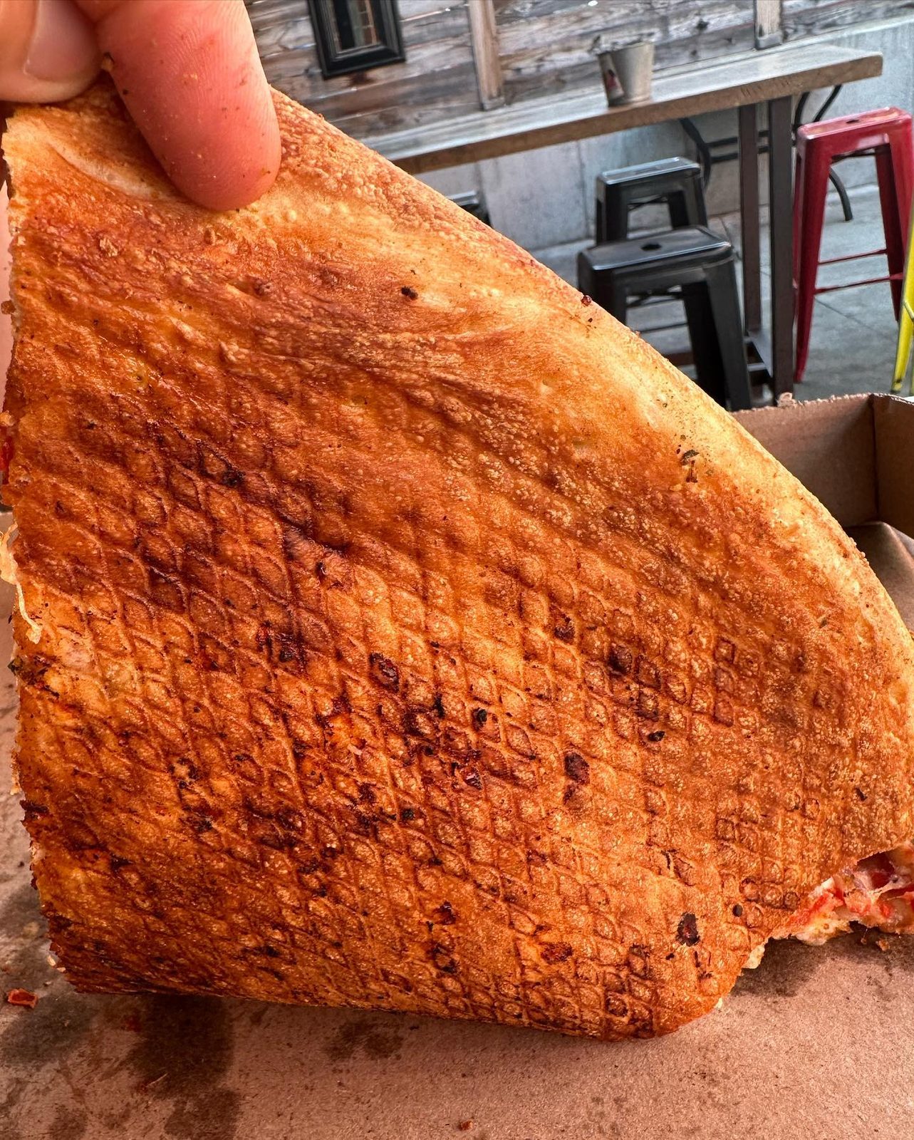 Underside of the crust showing the screen pattern at Mikey’s Late Night Slice